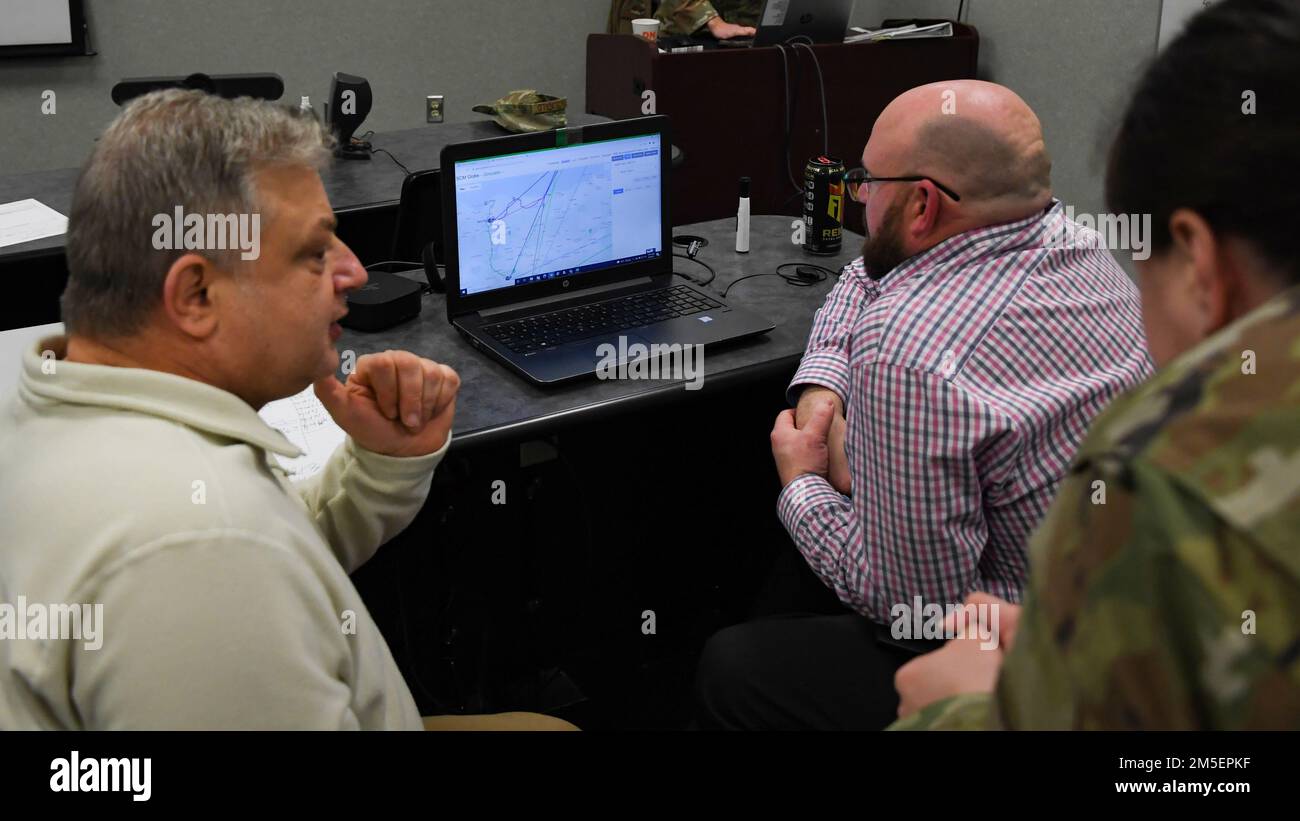 The team of (left to right) Dan Briscoe and Daniel Ward from Scott Air Force Base, Ohio, and Capt. Arianna Green from Fairchild AFB, Wash., work with a cloud-based simulator to see their disaster response plan in action during a training event at Sheppard AFB, Texas, March 8, 2022. The new tool in the Logistics Officer Readiness course in the 363rd Training Squadron provides a new level of critical thinking for military and civilian Airmen who will soon make the transition from a flight-level commander to director of operations for a unit. Stock Photo