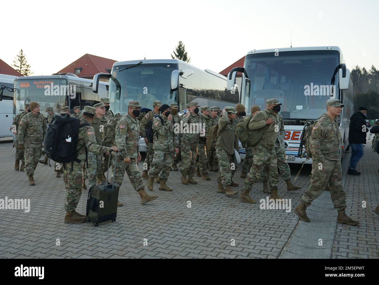 Soldiers from V Corps, Fort Knox, Ky., disembark from buses on Barton Barracks, Ansbach, Germany, March 8, 2022, as part of a deployment to Germany to build readiness, improve interoperability, reinforce allies and deter further Russian aggression. The deployment of U.S. forces here is a prudent measure that underpins NATO’s collective war-prevention aims, defensive orientation and commitment to protect all Allies. Stock Photo