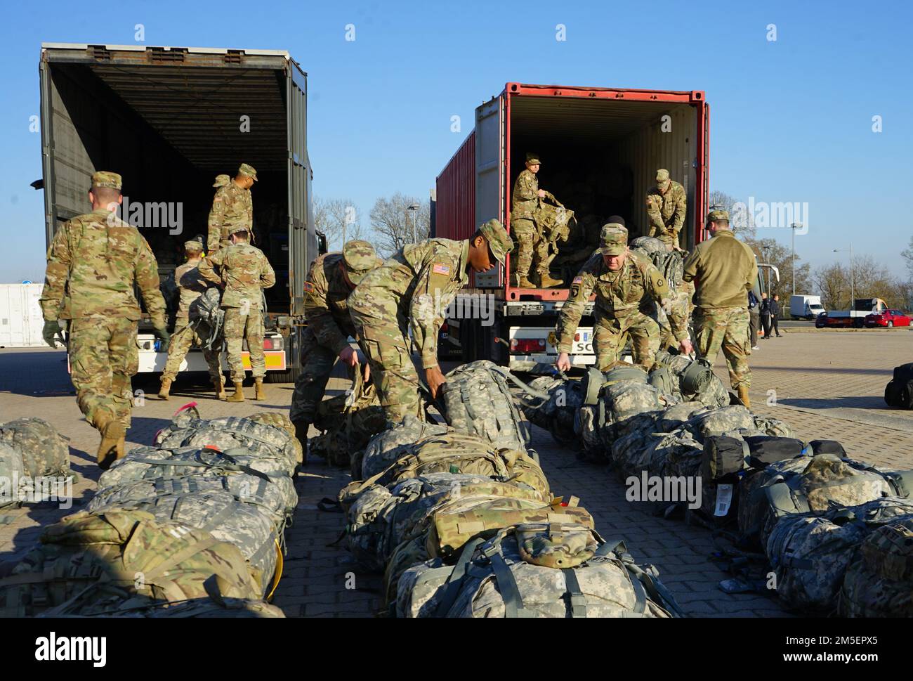 Soldiers from V Corps, Fort Knox, Ky., unload baggage from trucks on Barton Barracks, Ansbach, Germany, March 8, 2022, as part of a deployment to Germany to build readiness, improve interoperability, reinforce allies and deter further Russian aggression. The deployment of U.S. forces here is a prudent measure that underpins NATO’s collective war-prevention aims, defensive orientation and commitment to protect all Allies. Stock Photo