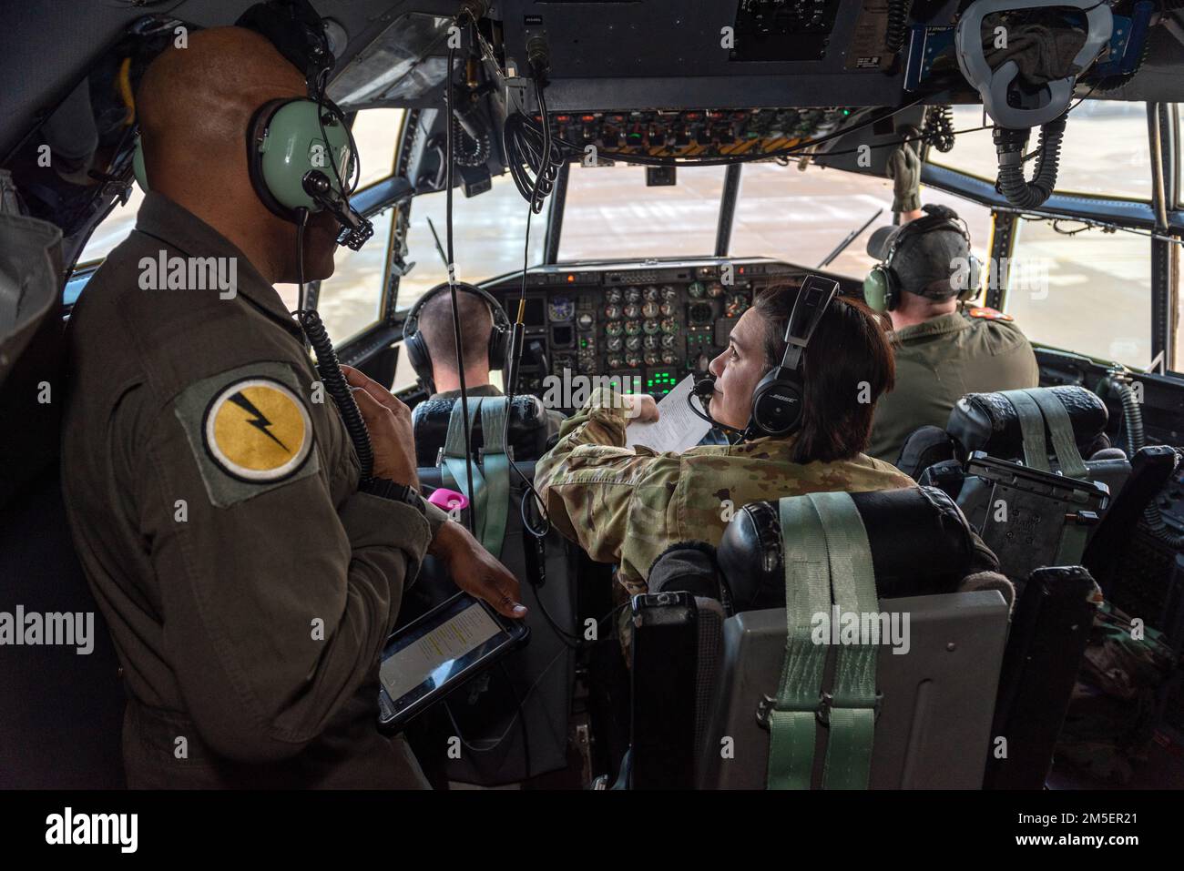 U.S. Air Force Master Sgt. Ashley Hutton, right, a C-130 flight engineer with the 169th Airlift Squadron, Illinois Air National Guard, trains with Senior Master Sgt. Shaun Bradshaw, an evaluator flight engineer with the 118th Airlift Squadron, Connecticut Air National Guard, on wet wing refueling operation in Peoria, Illinois, March 8, 2022. Wet wing refueling is a Specialized Fueling Operation which transfers fuel from an aircraft with at least one engine running into fuel support equipment. Stock Photo