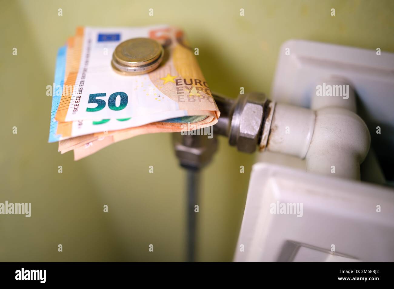 Euro banknotes on central heating, concept of expensive heating costs