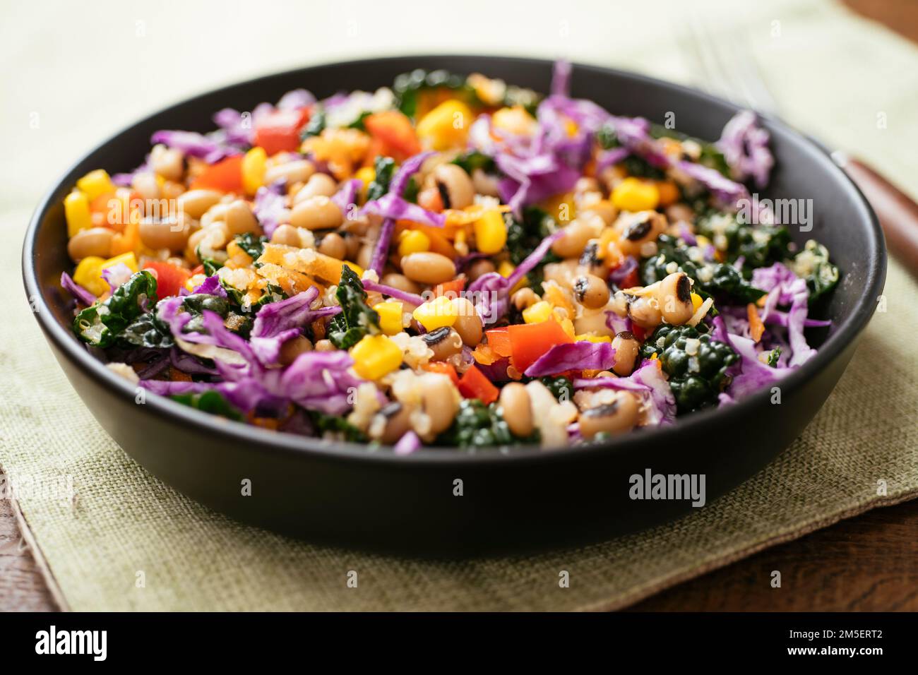 Colorful blackeyed pea and kale salad with quinoa, corn, bell pepper