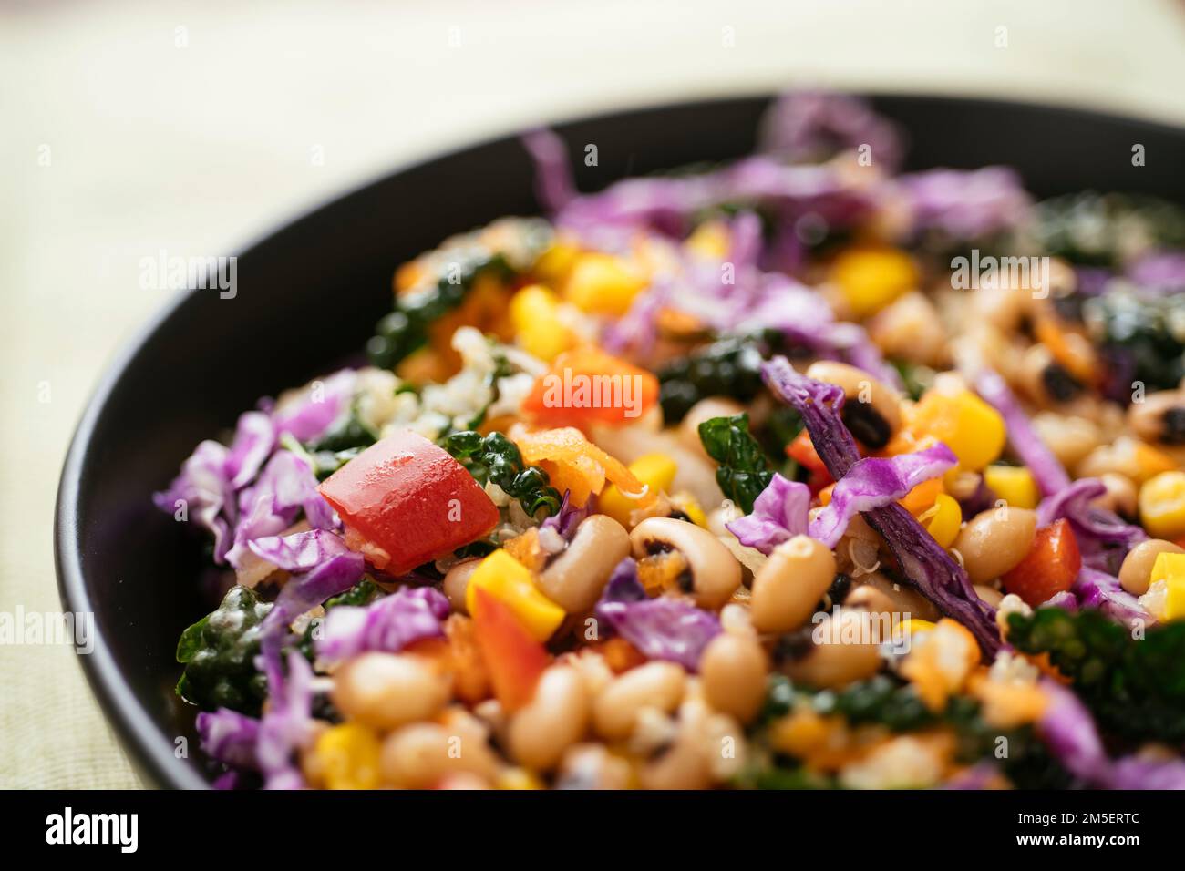 Colorful blackeyed pea and kale salad with quinoa, corn, bell pepper