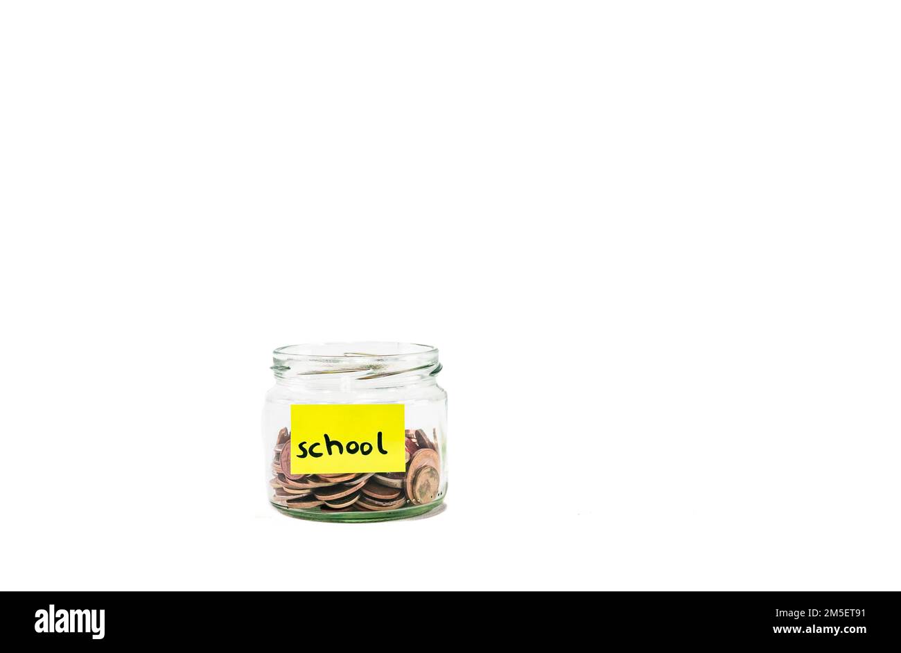 Close up glass jar with coins, moneybox, penny or piggy bank. Saving money euro coin for  school, college or university. Saving money penny bank. Stock Photo
