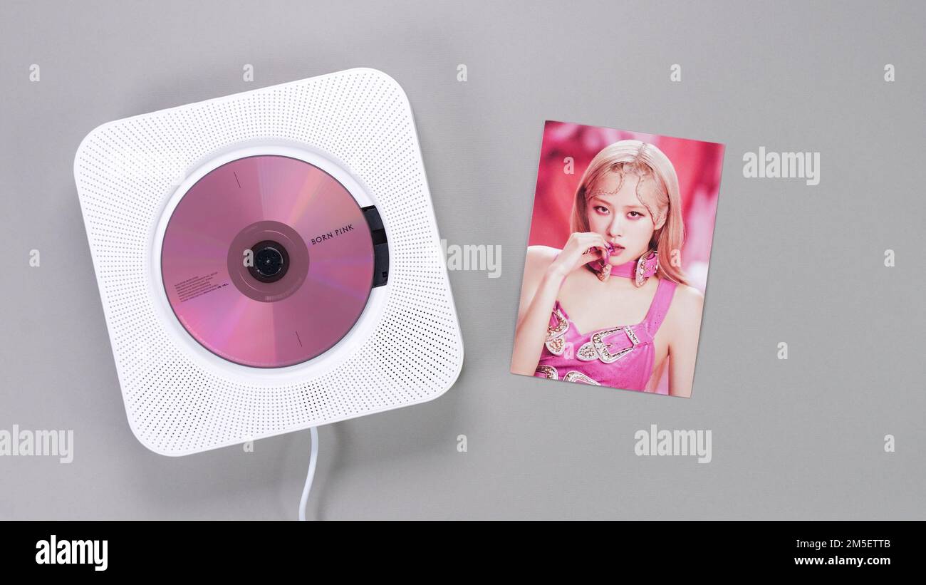 BlackPink BORN PINK 2nd Album collectible photo card with Rose on grey. Pink music CD in player. South Korean girl group BlackPink. Space for text. Ga Stock Photo