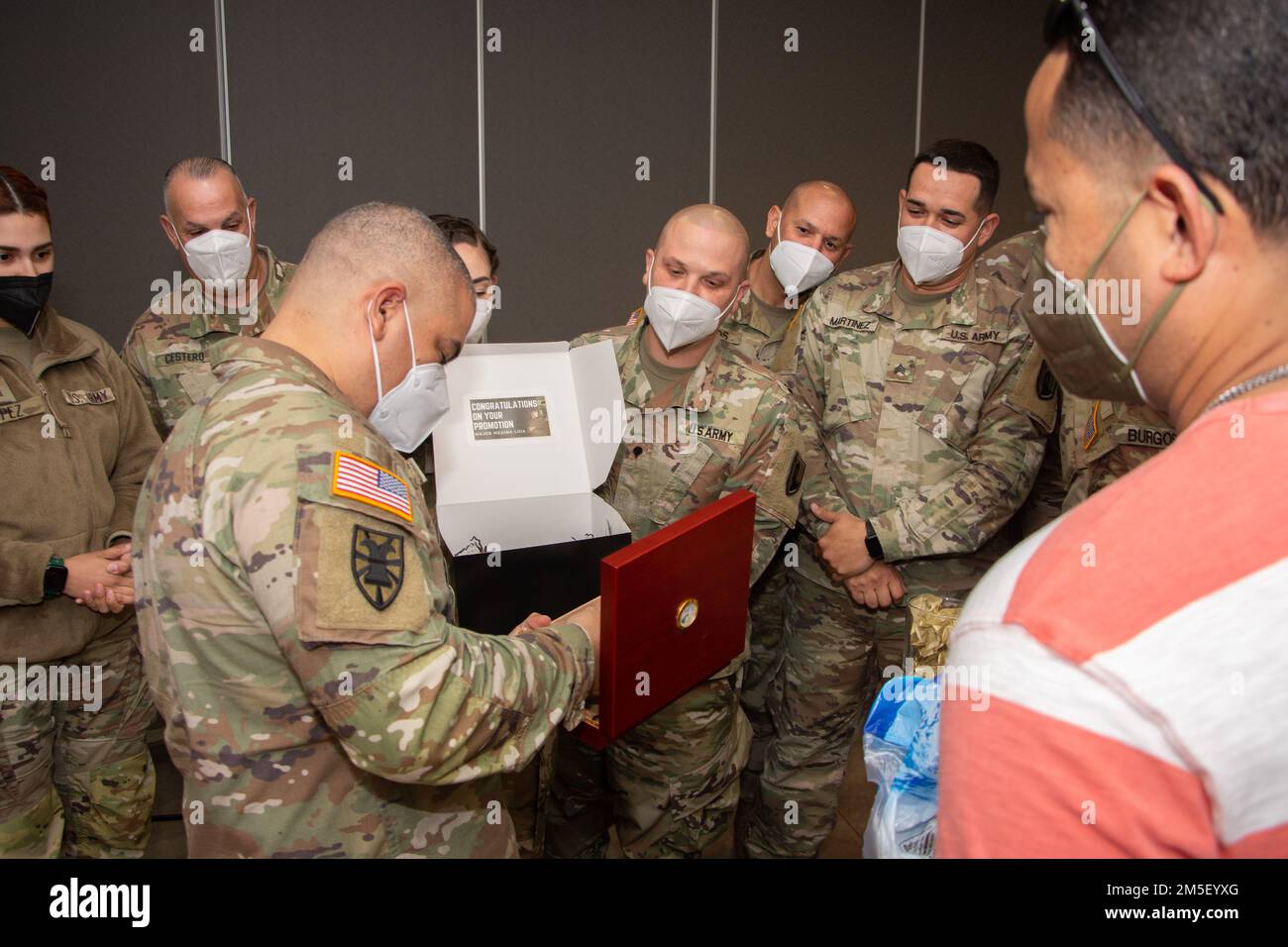 Soldier and Airmens of Joint Task Force - Puerto Rico gives a present to Major Luis E. Medina after his promotion ceremony at Fort Buchanan, March 9, 2022. The Puerto Rico Army National Guard requires capable and effective officers to lead and instruct our soldiers in the day-to-day operations. Stock Photo