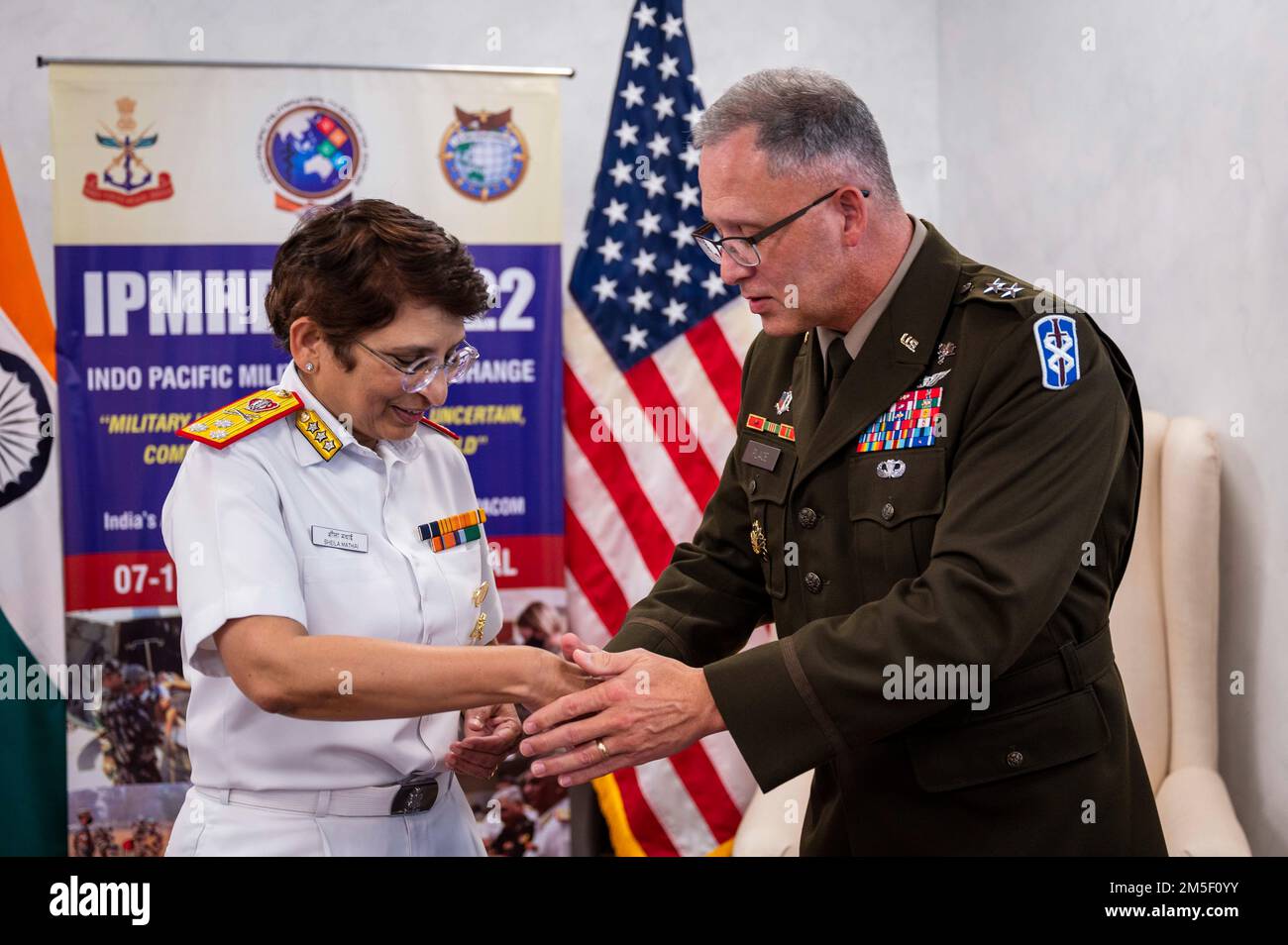 220309-N-XC372-1352 NEW DELHI (Mar. 9, 2022) Maj. Gen. Michael Place, Commanding General of 18th Medical Command, right, presents a coin to Surg V Adm Sheila S. Mothei, Director General of Organization and Personnel at the Armed Forces Medical Services, during the Indo-Pacific Military Health Exchange 2021-22. IPMHE 2021-22 is a multilateral premier military medical event co-hosted by India’s Armed Forces Medical Services and U.S. Indo-Pacific Command, where health professionals of various backgrounds integrate to develop relationships and shape global health engagement in the Indo-Pacific reg Stock Photo