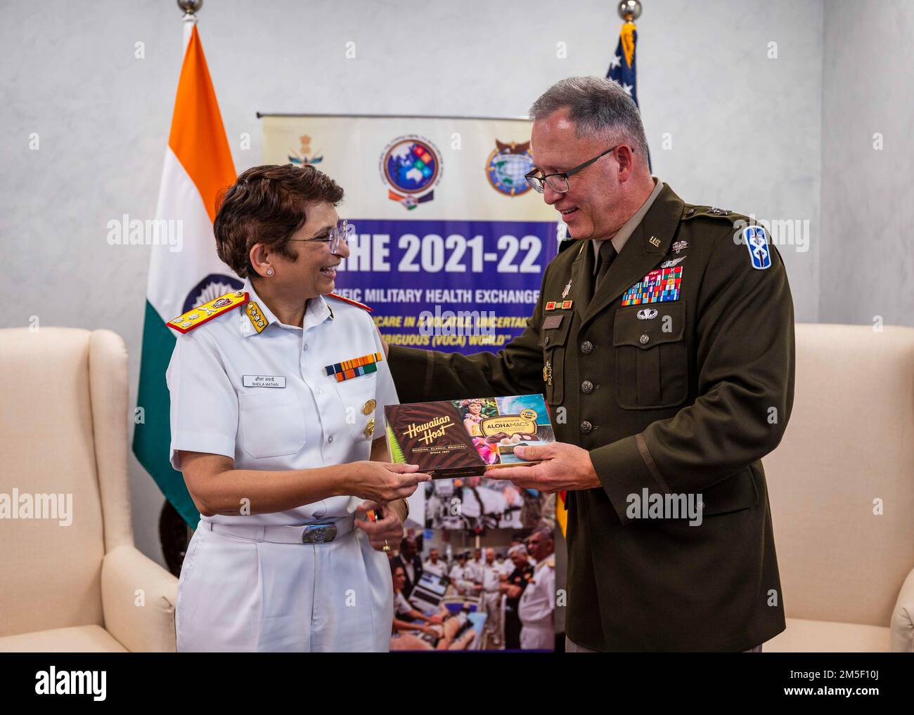 220309-N-XC372-1363 NEW DELHI (Mar. 9, 2022) Maj. Gen. Michael Place, Commanding General of 18th Medical Command, right, presents a gift to Surg V Adm Sheila S. Mothei, Director General of Organization and Personnel at the Armed Forces Medical Services, during the Indo-Pacific Military Health Exchange 2021-22. IPMHE 2021-22 is a multilateral premier military medical event co-hosted by India’s Armed Forces Medical Services and U.S. Indo-Pacific Command, where health professionals of various backgrounds integrate to develop relationships and shape global health engagement in the Indo-Pacific reg Stock Photo
