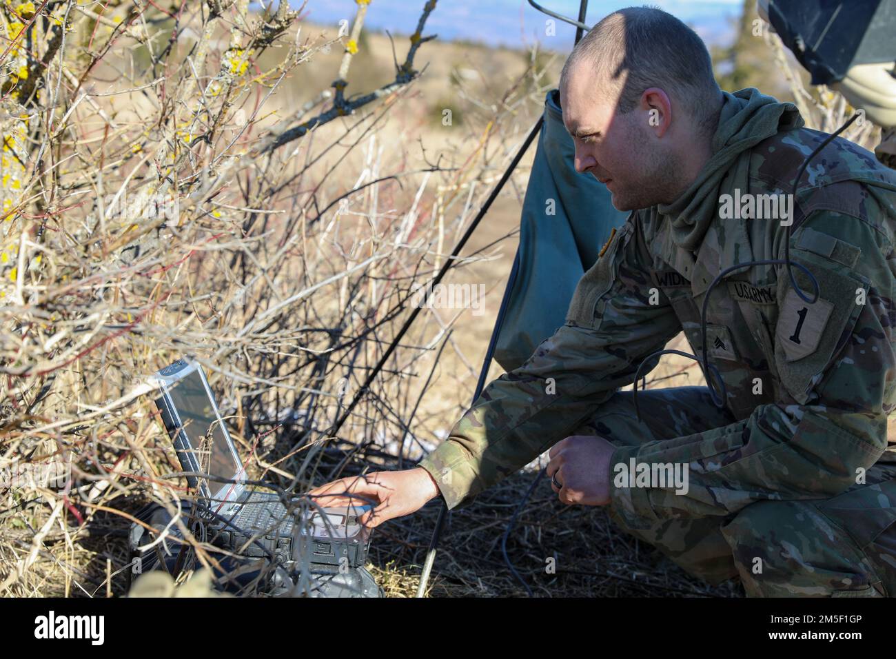 Sgt. Christopher Widner, a cavalry scout assigned to 2nd Battalion 34th Armored Regiment, 1st Armored Brigade Combat Team, 1st Infantry Division operates a computer to test the connection with an AeroVironment RQ-11 Raven before flying during Saber Strike 22 at Hradiště Military Area, Northwest Czech Republic, March 09, 2022. Stock Photo