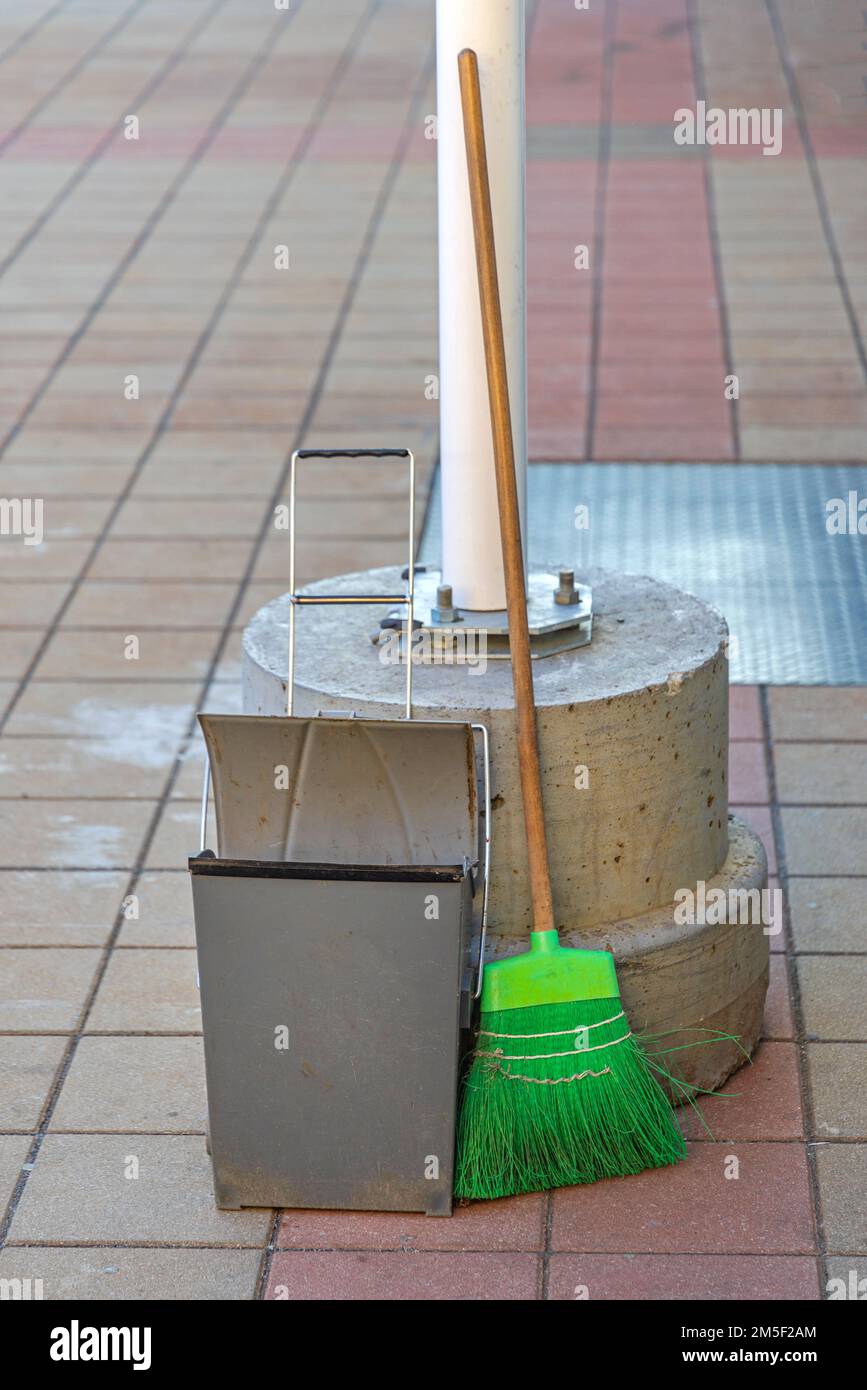 Green Broom With Dustpan at Tiled Pavement Stock Photo Alamy