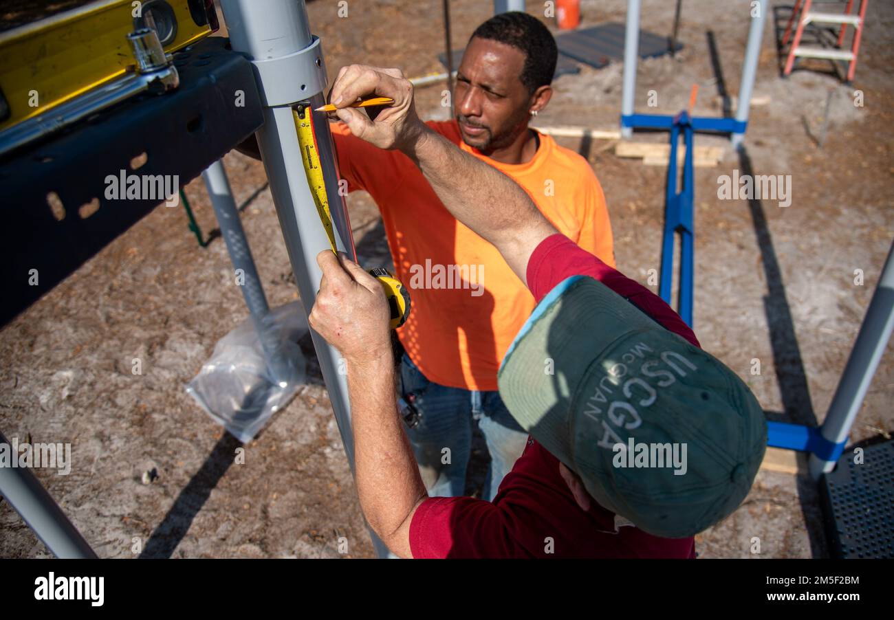 Contractors take measurements while building an all-inclusive park at MacDill Air Force Base, Florida, March 9, 2022. The playground was built specifically to meet the needs of the Exceptional Family Member Program and the Americans with Disabilities Act to ensure children of all ages and abilities have a safe area to play outdoors. Stock Photo