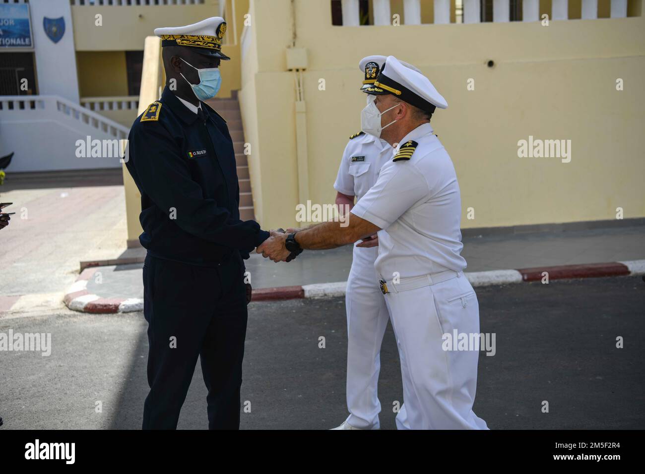 DAKAR, Senegal (Mar. 10, 2022) Rear Adm. Oumar Wade, Senegalese Chief of Navy, left, greets Capt. Michael Concannon, commanding officer of the Expeditionary Sea Base USS Hershel “Woody” Williams (ESB 4), at the Senegalese Naval Headquarters, in Dakar, Senegal, during Exercise Obangame Express 2022, Mar. 10, 2022. Obangame Express 2022, conducted by U.S. Naval Forces Africa, is an at-sea maritime exercise designed to improve cooperation among participating nations in order to increase maritime safety and security in the Gulf of Guinea and West Africa coastal regions. U.S. Sixth Fleet, headquart Stock Photo