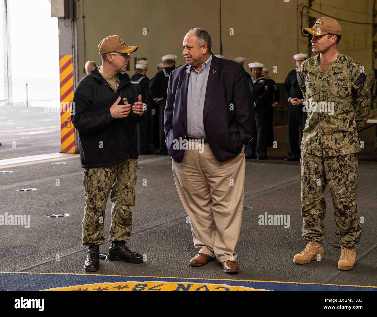 Secretary of the Navy Carlos Del Toro receives a brief from Capt. Paul ...