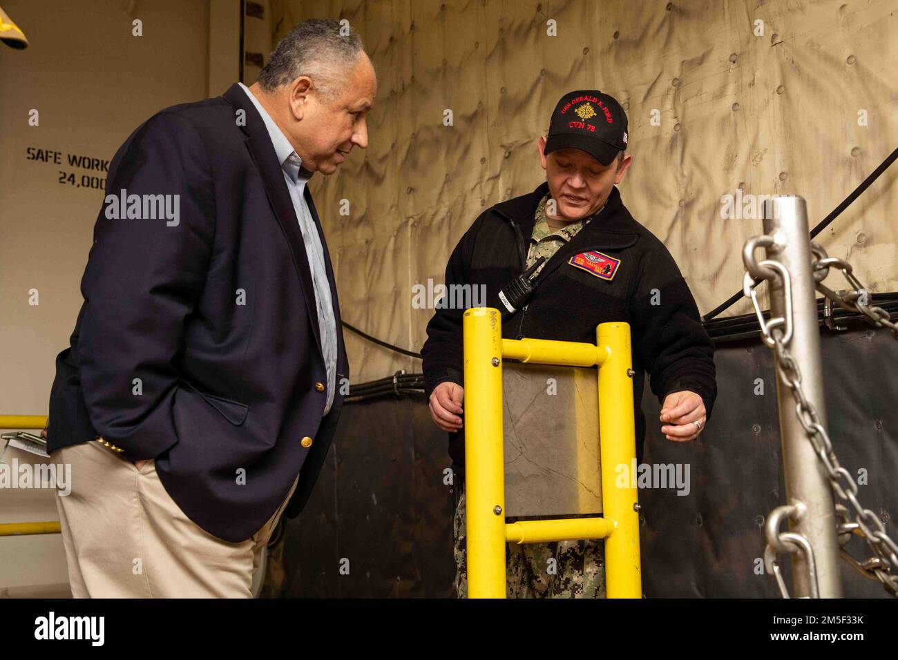 Secretary of the Navy Carlos Del Toro receives a brief from Lt. Cmdr ...