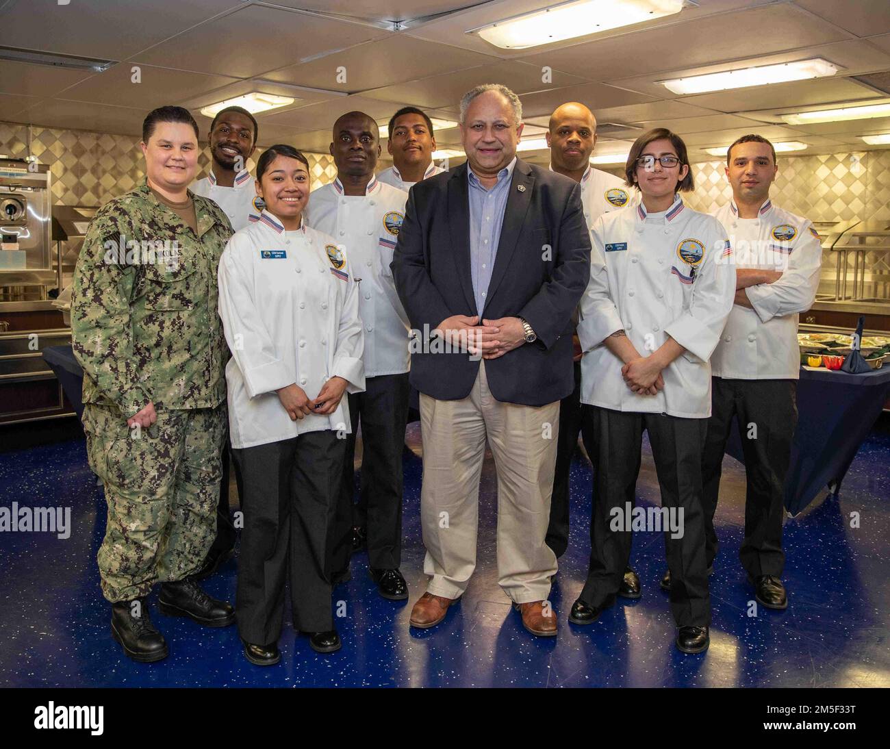 Secretary of the Navy Carlos Del Toro and Sailors assigned to USS Gerald R. Ford’s (CVN 78) supply department, pose for a group photo in the forward wardroom during a ship visit, March 10, 2022 in support of the centennial of Navy Aircraft Carriers. While onboard Del Toro conducted an all-hands call with the crew to congratulate them on their success during the ship’s planned incremental availability, and met the Ford’s leadership to discuss Ford-class unique capabilities ahead of the ship’s 2022 deployment. Stock Photo