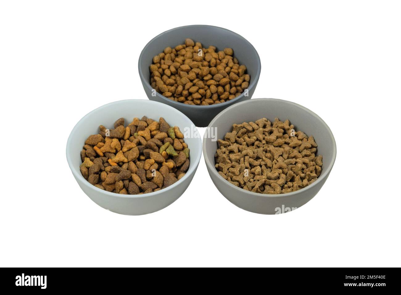 Variety of dry food for cats and dogs in ceramic bowls isolated on a