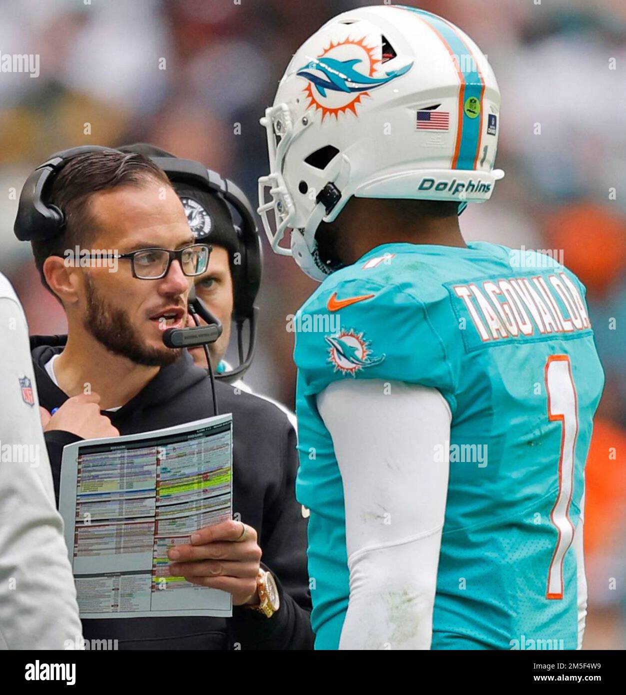 Miami Dolphins head coach Mike McDaniel talks with Miami Dolphins  quarterback Tua Tagovailoa (1) in the second quarter during the game  against the Green Bay Packers at Hard Rock Stadium in Miami