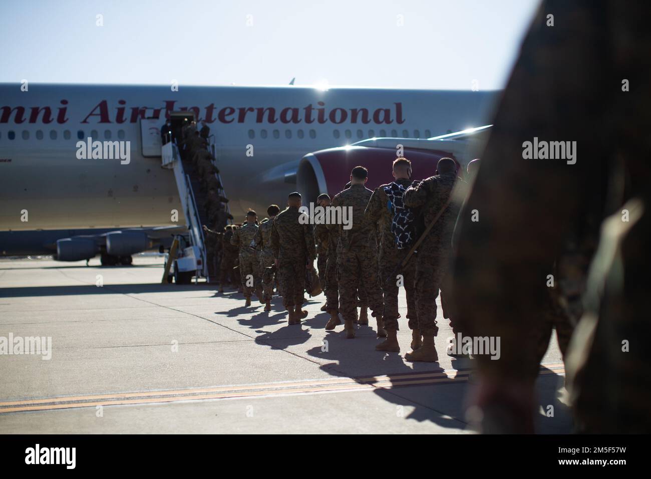 U.S. Marines with the Command Element, 5th Marine Regiment, Marine Rotational Force Darwin (MRF-D) 22 board a Boeing 777 at March Air Reserve Base, Riverside, California, March 10, 2022. MRF-D 22 is a six month rotation where U.S. Marines, the Australian Defence Force, and other allied and partner nations enhance their interoperability and readiness posture in the Indo-Pacific region. Stock Photo