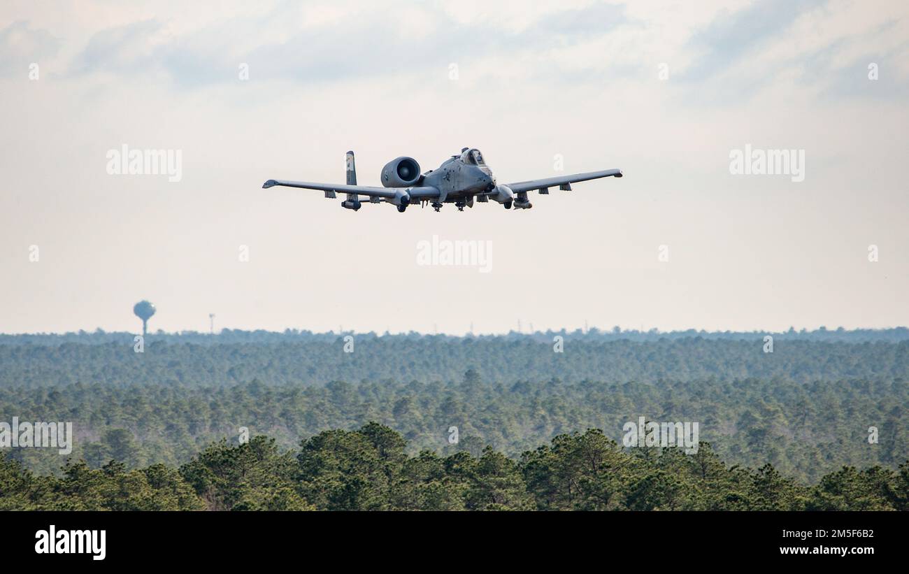 A U.S. Air Force 104th Fighter Squadron pilot, from the 175th Wing of the Maryland Air National Guard, flies a training mission in an A-10 Thunderbolt II March 10, 2022, at the Warren Grove Gunnery Range, Warren Grove, New Jersey. Brig. Gen. Patrick M. Kennedy, New Jersey Air National Guard Deputy Adjutant General, and Chief Master Sgt. Michael J. Rakauckas, New Jersey Air National Guard state command chief, observed the training during a visit. Stock Photo