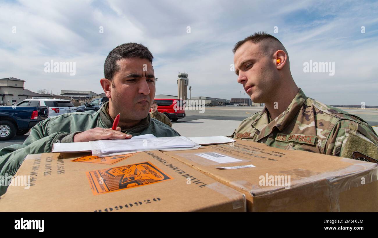Staff Sgt. Steven Landgren, 436th Aerial Port Squadron special handling supervisor, delivers foreign military sales cargo to a Tunisian air force C-130J Super Hercules aircrew member at Dover Air Force Base, Delaware, March 10, 2022. The U.S. and Tunisia have enjoyed strong diplomatic relations for over 200 years, beginning when the two countries signed the Treaty of Peace and Friendship in 1797. Due to its strategic geographic location, Dover AFB supports approximately $3.5 billion worth of FMS operations annually. Stock Photo