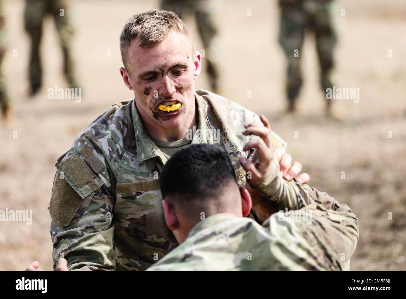 U.S. Army Reserve Spc. Austin Pogreba, a chemical, biological, radiological, and nuclear specialist, with the 432nd Civil Affairs Battalion, competes in the combatives portion of the 352nd Civil Affairs Command Best Warrior Competition at Fort A.P. Hill, V.A., March 10, 2022. The three-day warrior competition challenges competitors to overcome extensive tasks and missions designed to test their warfighting knowledge, physical fitness, battlefield skills in hands-on situational testing, and individual oral and written examinations. Stock Photo