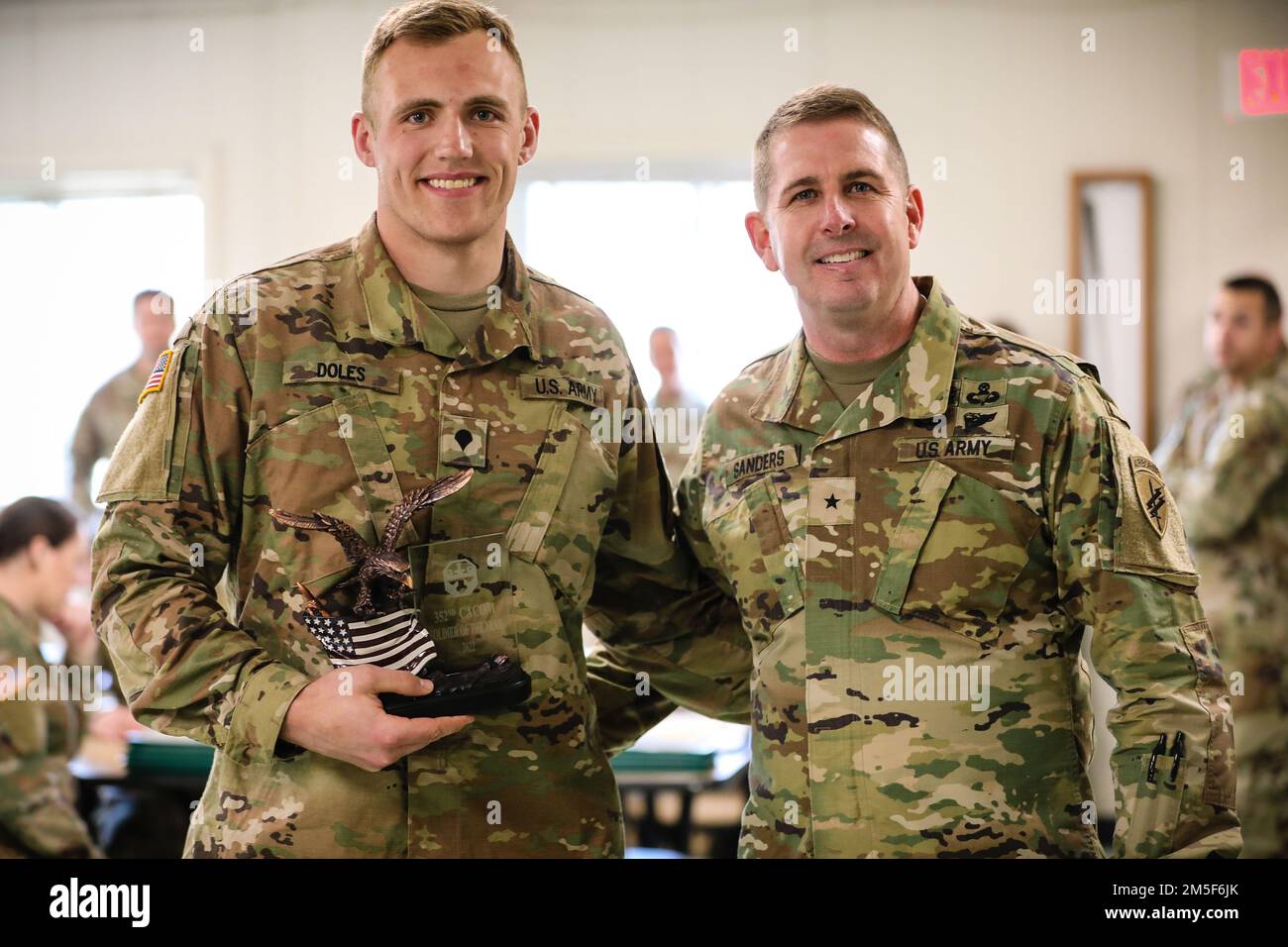 U.S Army Reserve Spc. Thomas Doles, left, a civil affairs specialist with the 489th Civil Affairs Battalion, receives the 352nd Civil Affairs Command’s Soldier of the Year award from Brig. Gen. James Sanders, right, the commanding general of the 352nd Civil Affairs Command, during the 352nd Civil Affairs Command Best Warrior Competition at Fort A.P. Hill, V.A. March 10, 2022. The three-day event challenges competitors to overcome an extensive set of tasks and missions designed to test their warfighting knowledge, physical fitness, battlefield skills in hands-on situational testing, as well as Stock Photo
