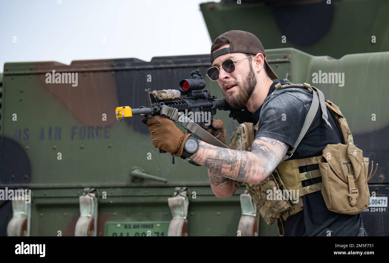 An Airman acting as an opposing force strike team member approaches a ...