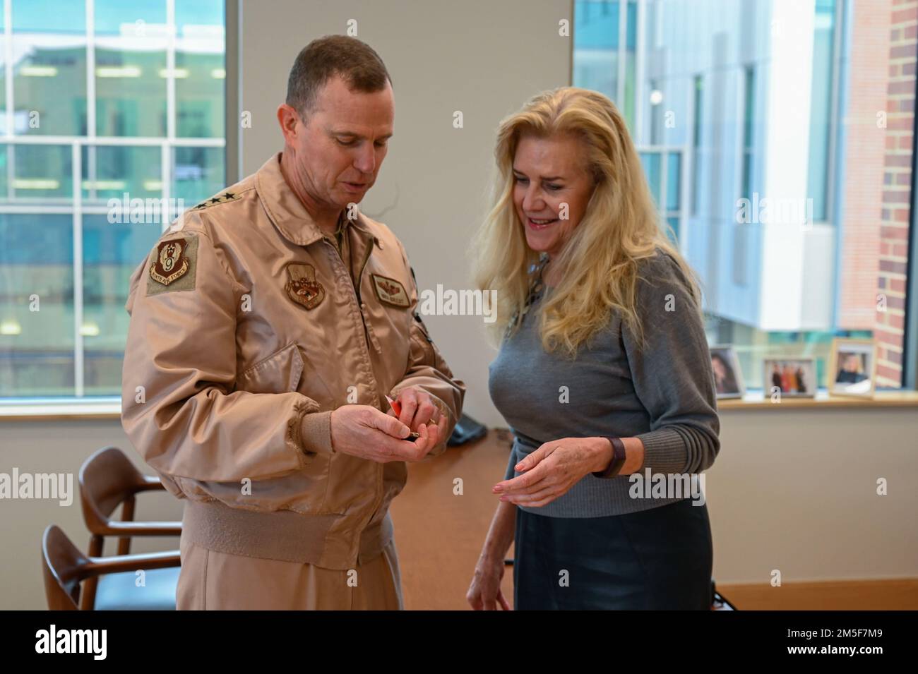 U.S. Air Force Lt. Gen. Greg Guillot, Ninth Air Force (Air Forces Central) commander, awards a coin to Wendy York, Wilbur O. and Ann Powers College of Business dean, during an engagement at Clemson University, South Carolina, March 10, 2022. Guillot and York discussed the importance of creating all-inclusive environments for new team members. They also emphasized the need to prioritize equality. Stock Photo