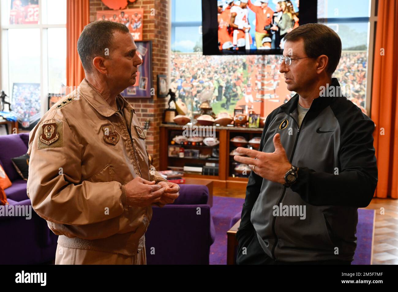 U.S. Air Force Lt. Gen. Greg Guillot, Ninth Air Force (Air Forces Central) commander, speaks to Dabo Swinney, Clemson University Football head coach, during an engagement in South Carolina, March 10, 2022. Guillot spoke with Swinney about leadership, teamwork, and the value of individual development within large organizations. Stock Photo