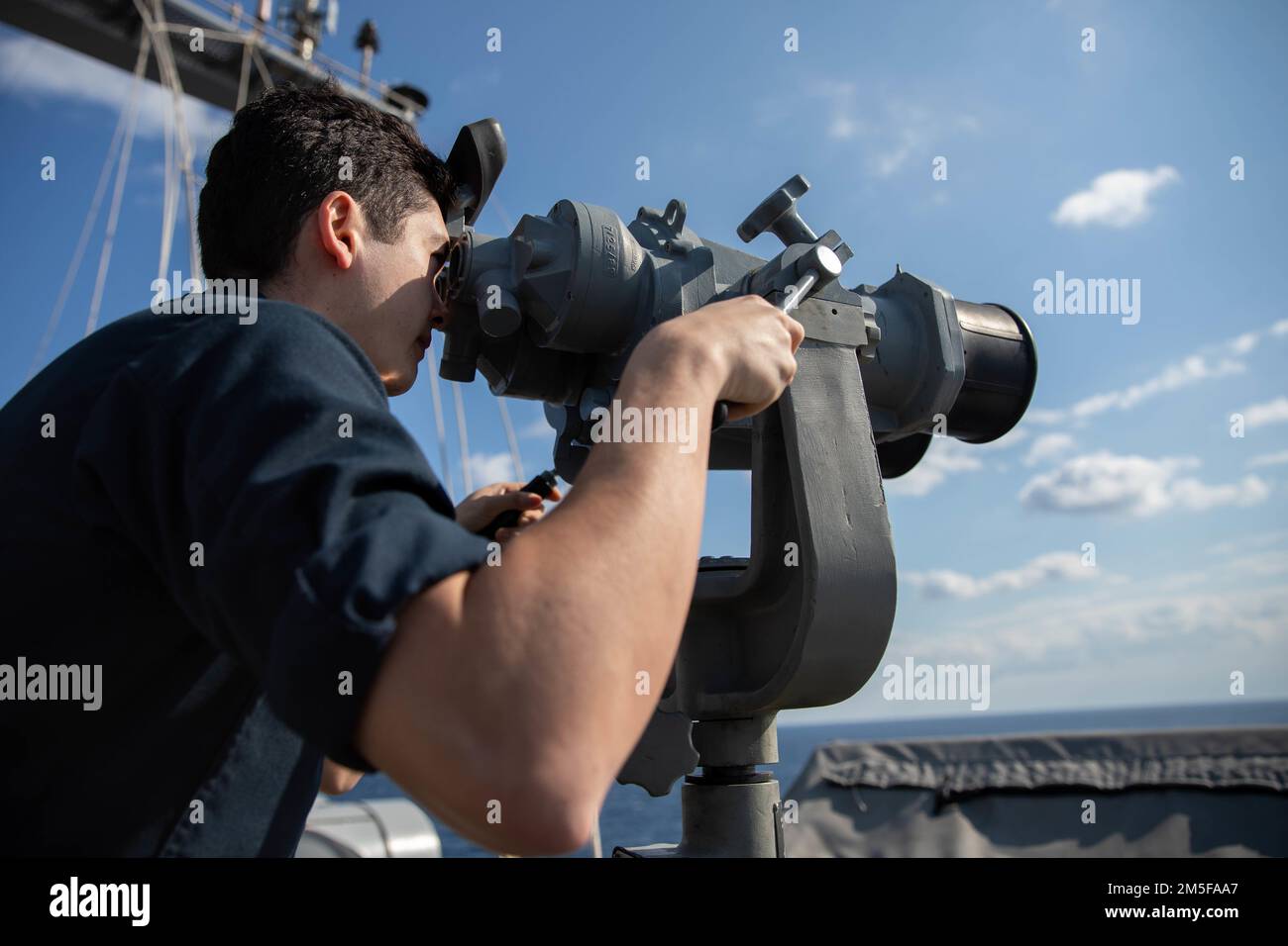 220311-N-QI593-1037 IONIAN SEA (Mar. 11, 2022) Lt. j.g. Alex Dale, from Fairfax, Virginia, scans for surface contacts aboard the Nimitz-class aircraft carrier USS Harry S. Truman (CVN 75), Mar. 11, 2022. The Harry S. Truman Carrier Strike Group is on a scheduled deployment in the U.S. Sixth Fleet area of operations in support of U.S., allied and partner interests in Europe and Africa. Stock Photo