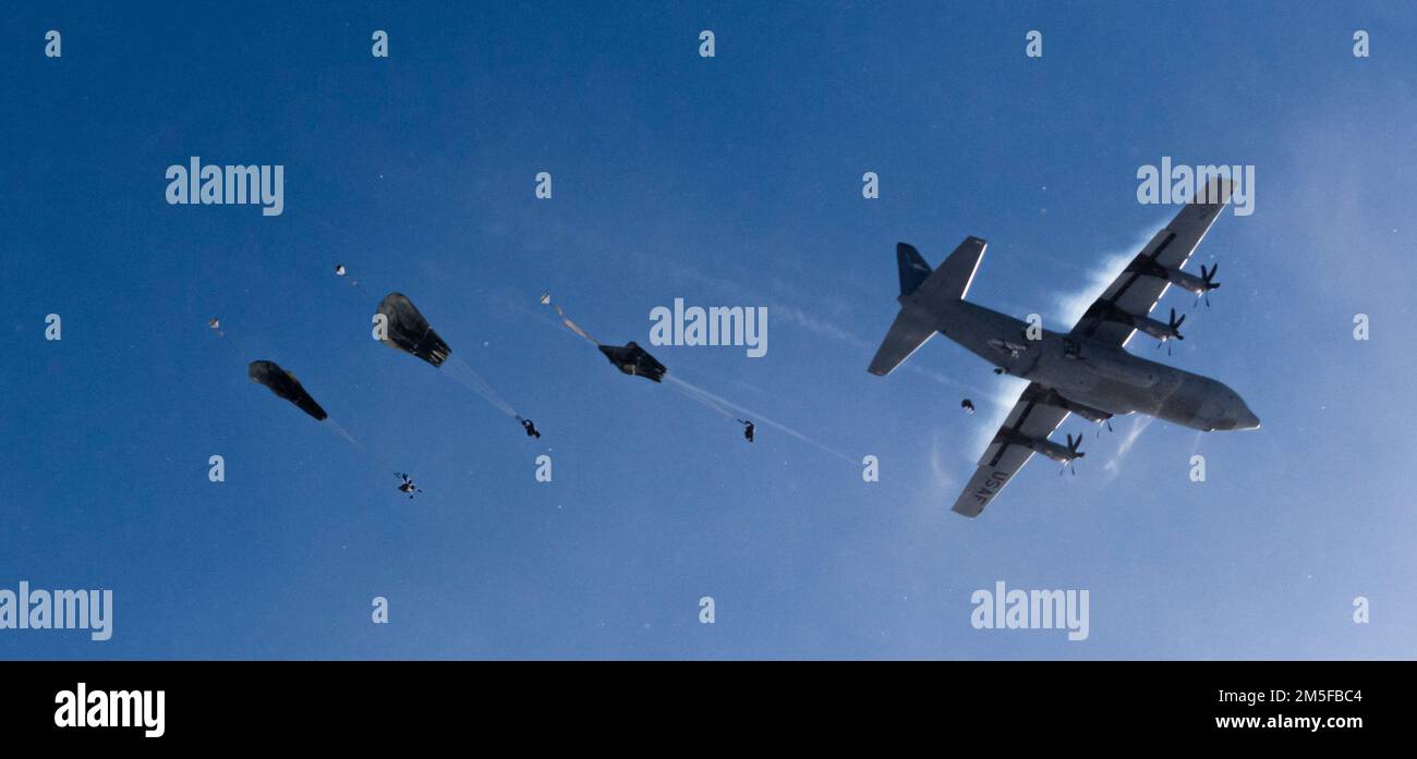 Members of the United States Army Alaska along with members of the 3rd Battalion, Royal 22e Régiment Canadian Army parachute to the ground after jumping out of C-130 and C-17 aircrafts over the training area of Fort Greely, AK, during Exercise Joint Pacific Multinational Readiness Center 22-02 on March 12, 2022.  Please Credit Master Sailor Dan Bard Canadian Forces Combat Camera Stock Photo