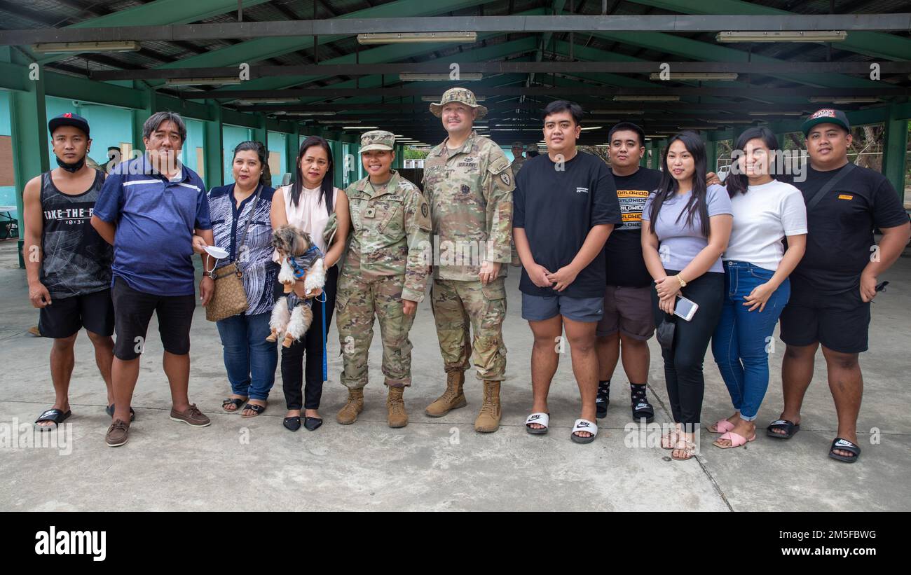 U.S. Army Spc. Jessica Ramelb, a unit supply specialist with 3rd Battalion, 7th Field Artillery Regiment, 3rd Infantry Brigade Combat Team, 25th Infantry Division, poses for photos with family members and her first sergeant during Salaknib 2022 on Fort Magsaysay, Nueva Ecija, Philippines, March 11, 2022. The reunion was the first time Ramelb had seen her mom in nearly five years after immigrating to the United States with her father. Ramelb is participating in Salaknib, an annual Philippine Army-led, U.S. Army Pacific sponsored bilateral exercise designed to enhance U.S. and Philippine Army ca Stock Photo