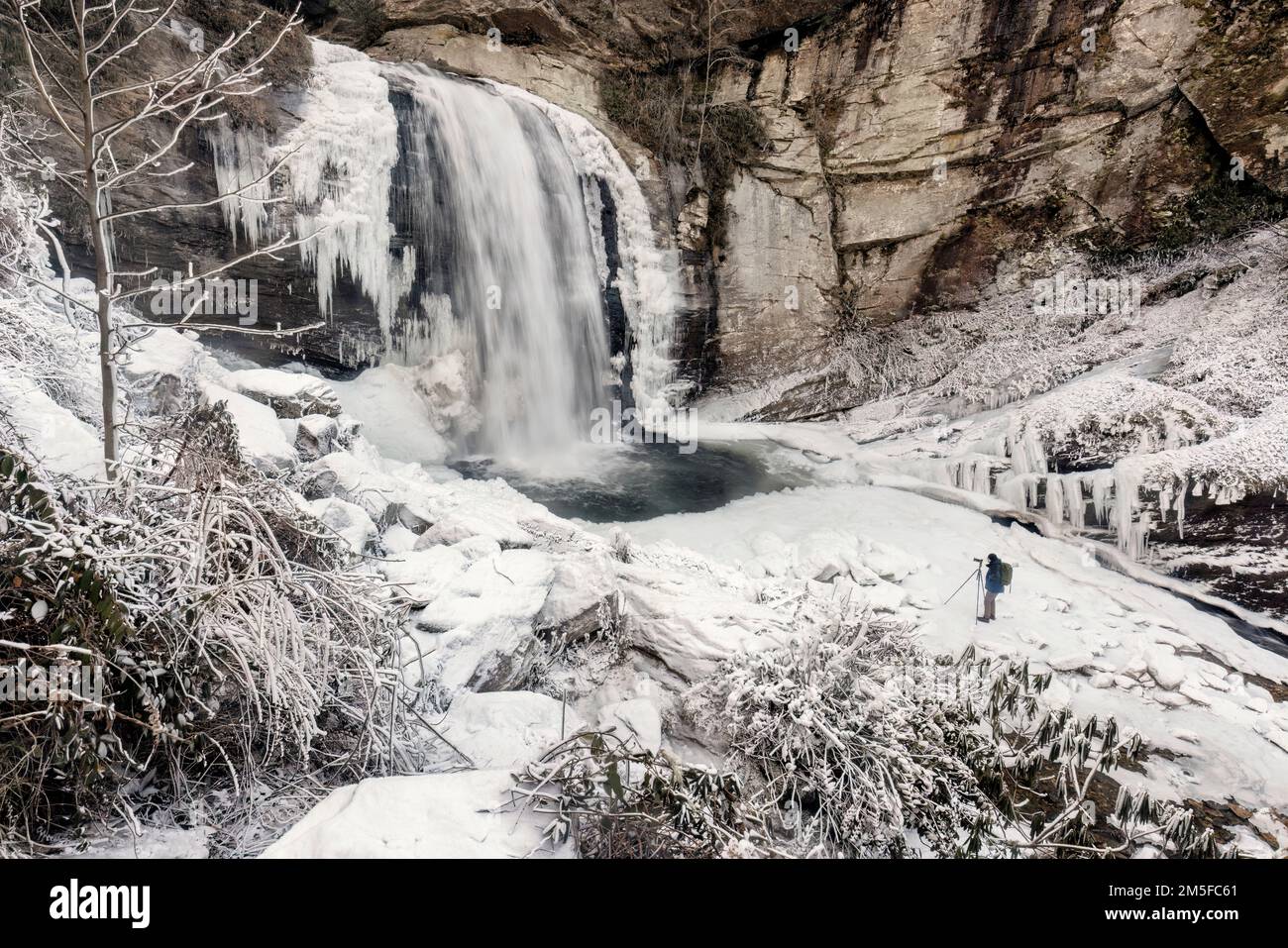 Photographer at Looking Glass Falls in winter - Pisgah National Forest - near Brevard, North Carolina USA Stock Photo