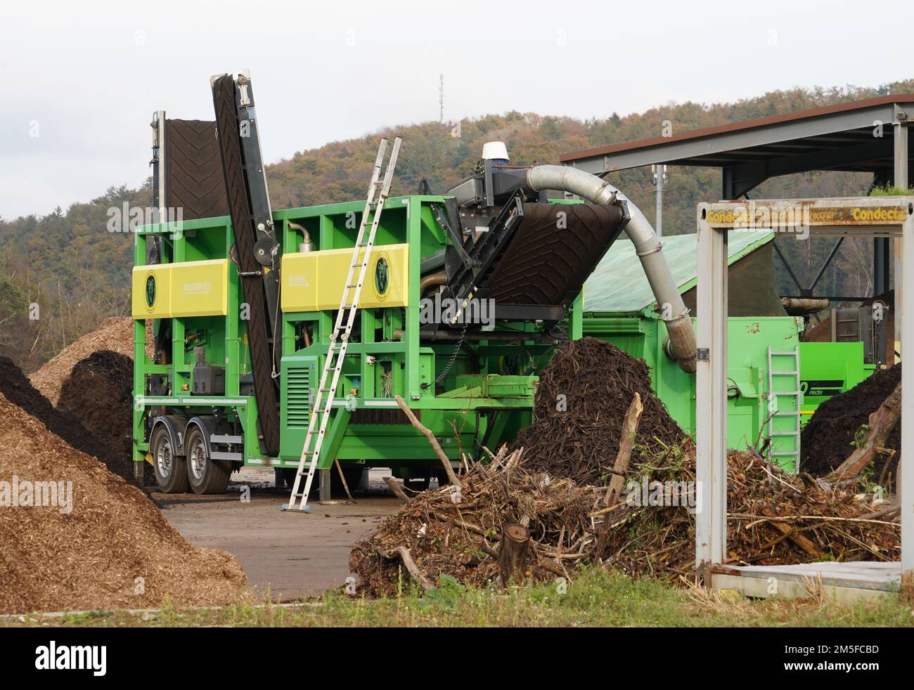 Side view on green starscreen machine producing biomass or reducing organic material. Stock Photo