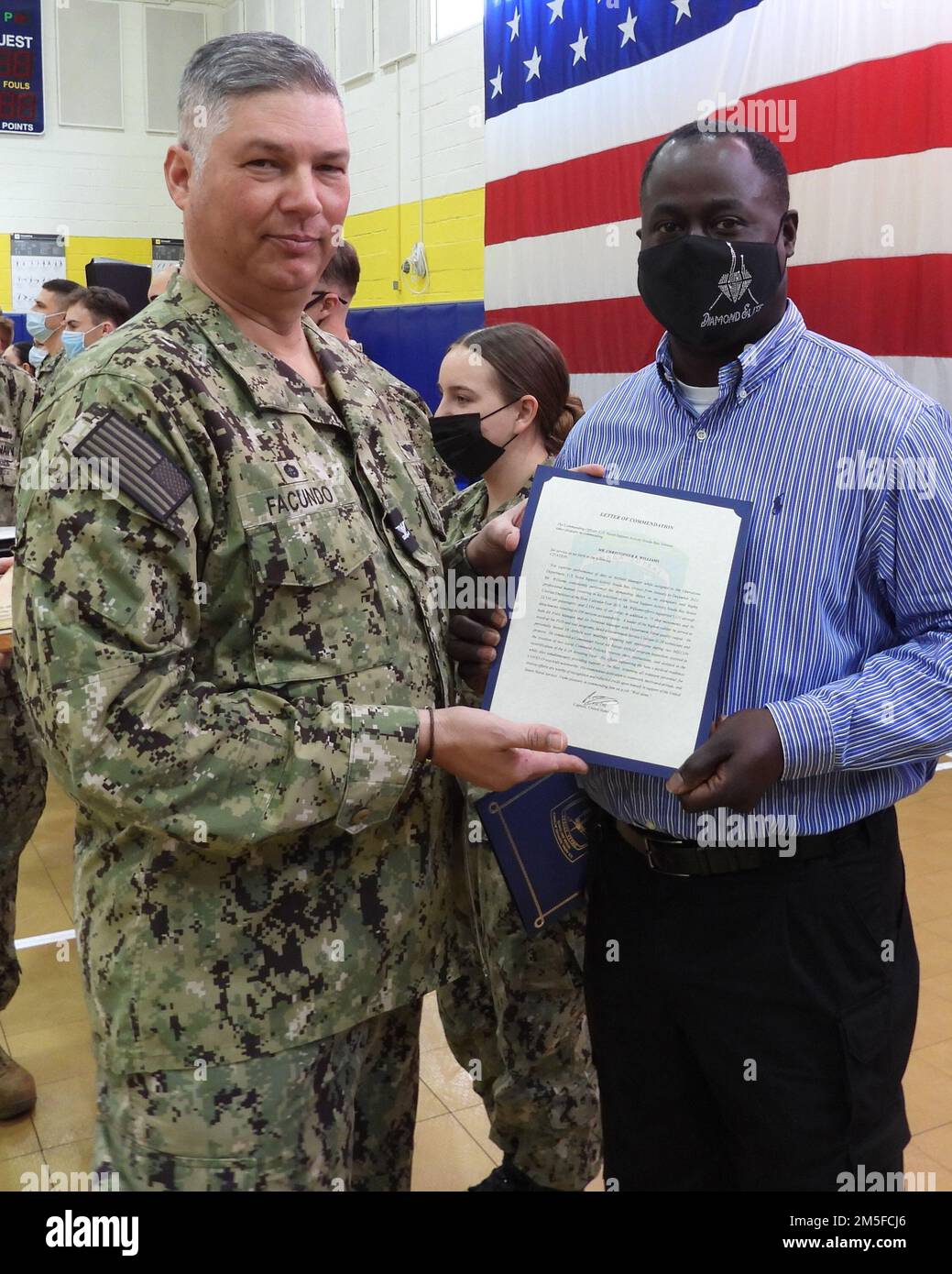 220311-O-AH609-1013-GR NAVAL SUPPORT ACTIVITY SOUDA BAY, Greece (Mar. 11, 2022) Christopher R. Williams received his Senior Civilian of the Year award from Navy Capt. Rafael C. Facundo, commanding officer, Naval Support Activity Souda Bay, during an Awards at Quarters ceremony in the base gym on Mar. 11, 2022. Naval Support Activity Souda Bay is an operational ashore base that enables U.S., allied, and partner nation forces to be where they are needed when they are needed to ensure security and stability in the European, African, and Central Command areas of responsibility. Stock Photo