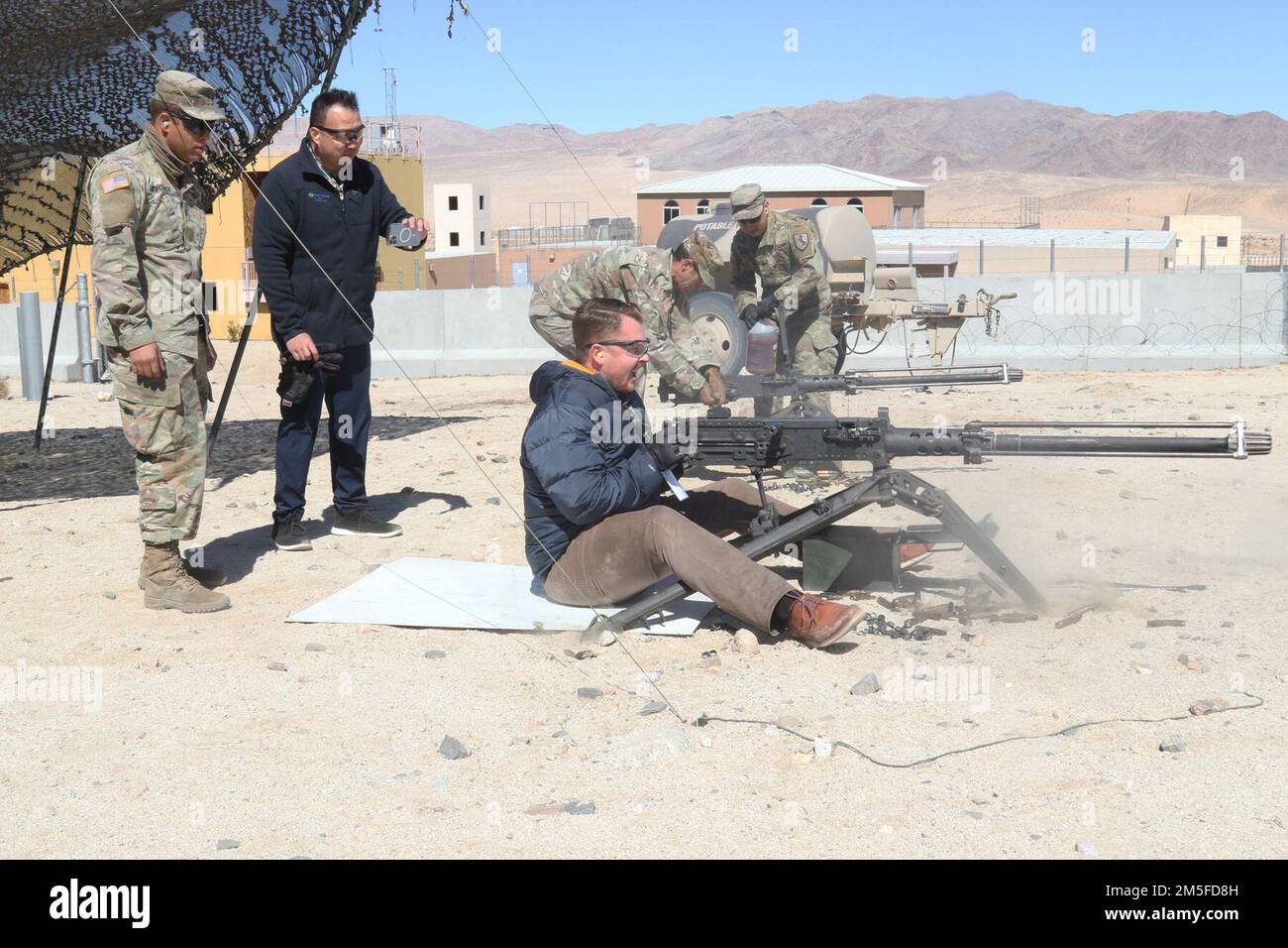 John Kozyra, the chief philanthropy officer from St. Mary Medical Center, fires an M2 .50 caliber machine gun March 11, during Weed Army Community Hospital’s Leadership Summit at Fort Irwin, Calif. (Photo by Kimberly Hackbarth/ Weed ACH Public Affairs Office) Stock Photo