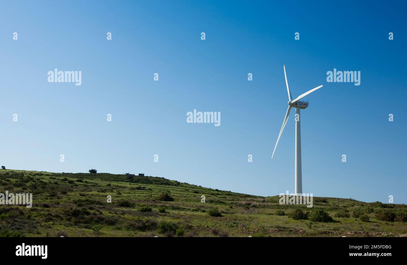 A Wind Power Turbine on a hill with a blue sky background Stock Photo ...