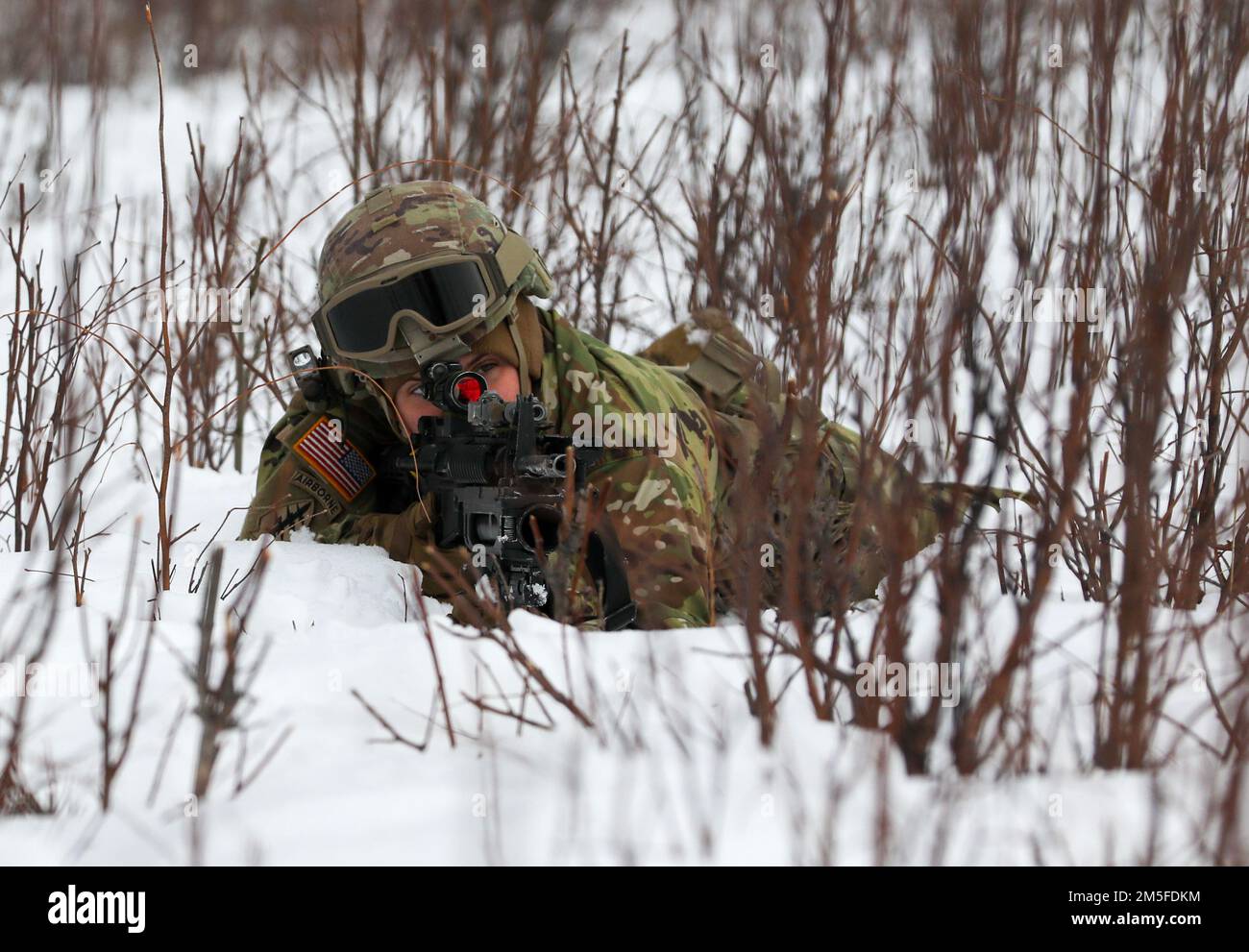 Alaska Army National Guard Spc. Megan Koszarek with Avalanche Company, 1-297th Infantry Battalion, participates in squad and platoon situational training exercises (STX) at Alcantra armory in Wasilla, Alaska, March 11, 2022. An STX is a short, scenario-driven, mission-oriented exercise designed to train one collective task or a group of related tasks or battle drills. For the A-Co. Soldiers, the STX allows for evaluation of basic Soldier skills and leadership competencies to determine proficiency and certify the platoon to conduct live-fire exercises. It also reinforces previous training that Stock Photo