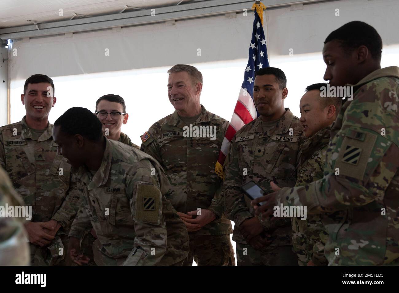 Chief of Staff of the Army Gen. James C. McConville laughs with Soldiers during the Bavarian Minister President’s luncheon held at Grafenwoehr Training Area, Germany on March 11, 2022. The luncheon acted as a way to strengthen Soldier morale and show support for Germany and America’s ongoing NATO partnership. Stock Photo