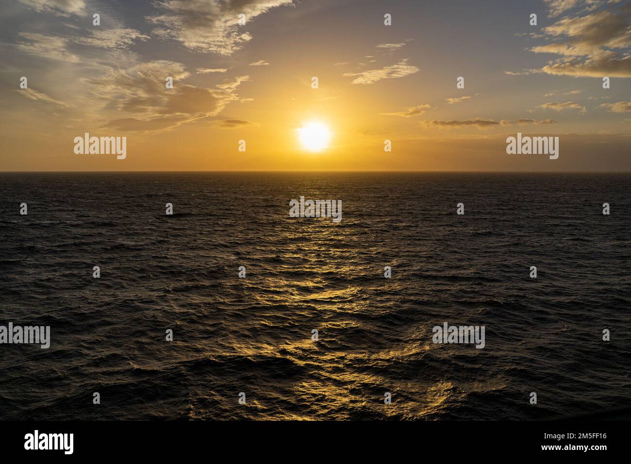 A sunrise view over seascape with water waves reflecting sunlight Stock ...