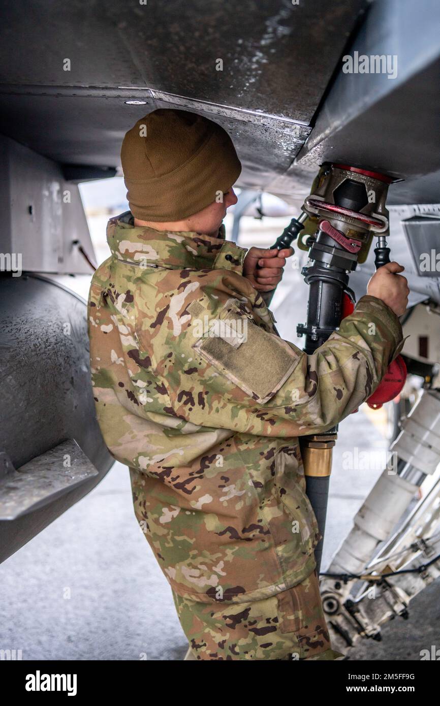U.S. Air Force Staff Sgt. Benjamin Preston, an F-16 crew chief assigned to the Ohio National Guard’s 180th Fighter Wing, refuels an F-16 Fighting Falcon, assigned to the 180FW, at Joint Base Elmendorf-Richardson, Alaska, during U.S. Northern Command Exercise ARCTIC EDGE 2022, March 11, 2022. AE22 is a biennial homeland defense exercise designed for U.S. and Canadian Armed Forces to demonstrate and exercise a joint capability to rapidly deploy and operate in the Arctic. Stock Photo