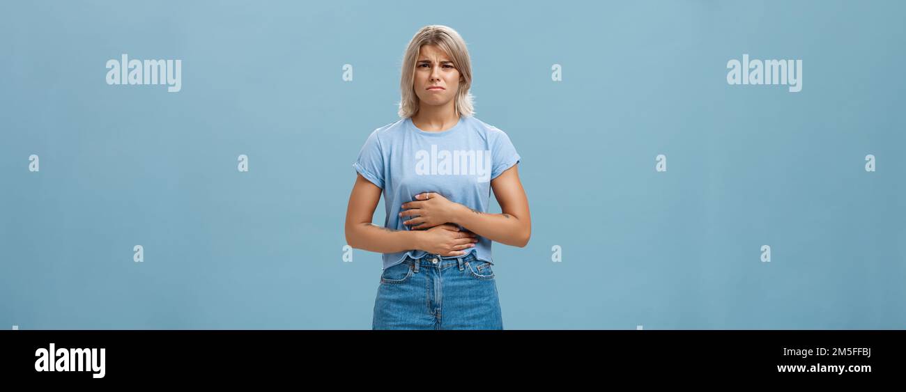 Portrait of displeased intense attractive young blonde girl with