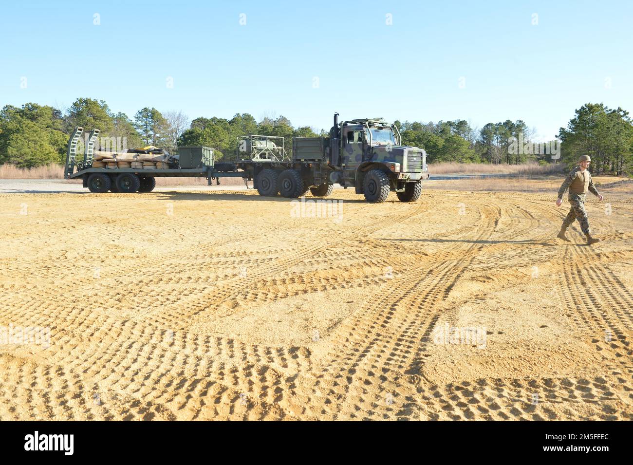 The blue-green teams of the Navy and Marine Corps expeditionary forces from Navy Cargo Handling Battalion EIGHT (NCHB-8) expeditionary fuels team and Marine Corps 6th Engineer Support Battalion Bulk Fuels Team, joined up at Joint Base McGuire-Dix-Lakehurst, New Jersey, to integrate and train in coordination to focus on a concept of employment experimentation with the Expeditionary Fuel Dispensing System–Small (EFDS-S). Stock Photo