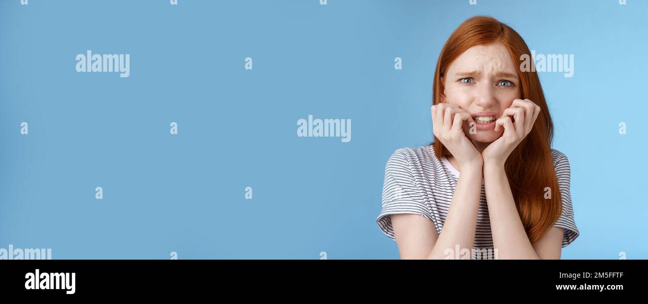 Worried scared young panicking redhead young girl feeling