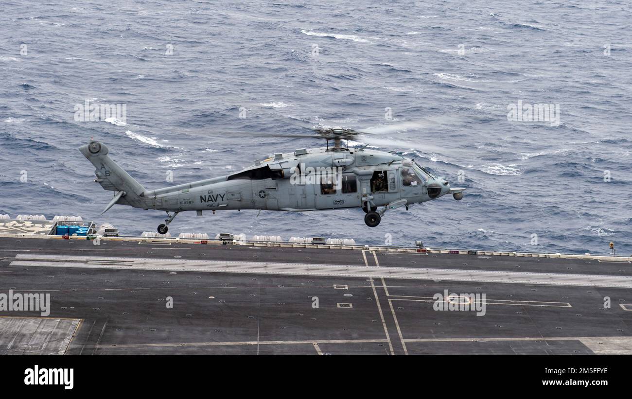 220312-N-JU123-2059 IONIAN SEA (Mar. 12, 2022) An MH-60S Sea Hawk helicopter, assigned to the 'Dragonslayers' of Helicopter Sea Combat Squadron (HSC) 11, takes off from the flight deck of the Nimitz-class aircraft carrier USS Harry S. Truman (CVN 75), Mar. 12, 2022. The Harry S. Truman Carrier Strike Group is on a scheduled deployment in the U.S. Sixth Fleet area of operations in support of U.S., allied and partner interests in Europe and Africa. Stock Photo