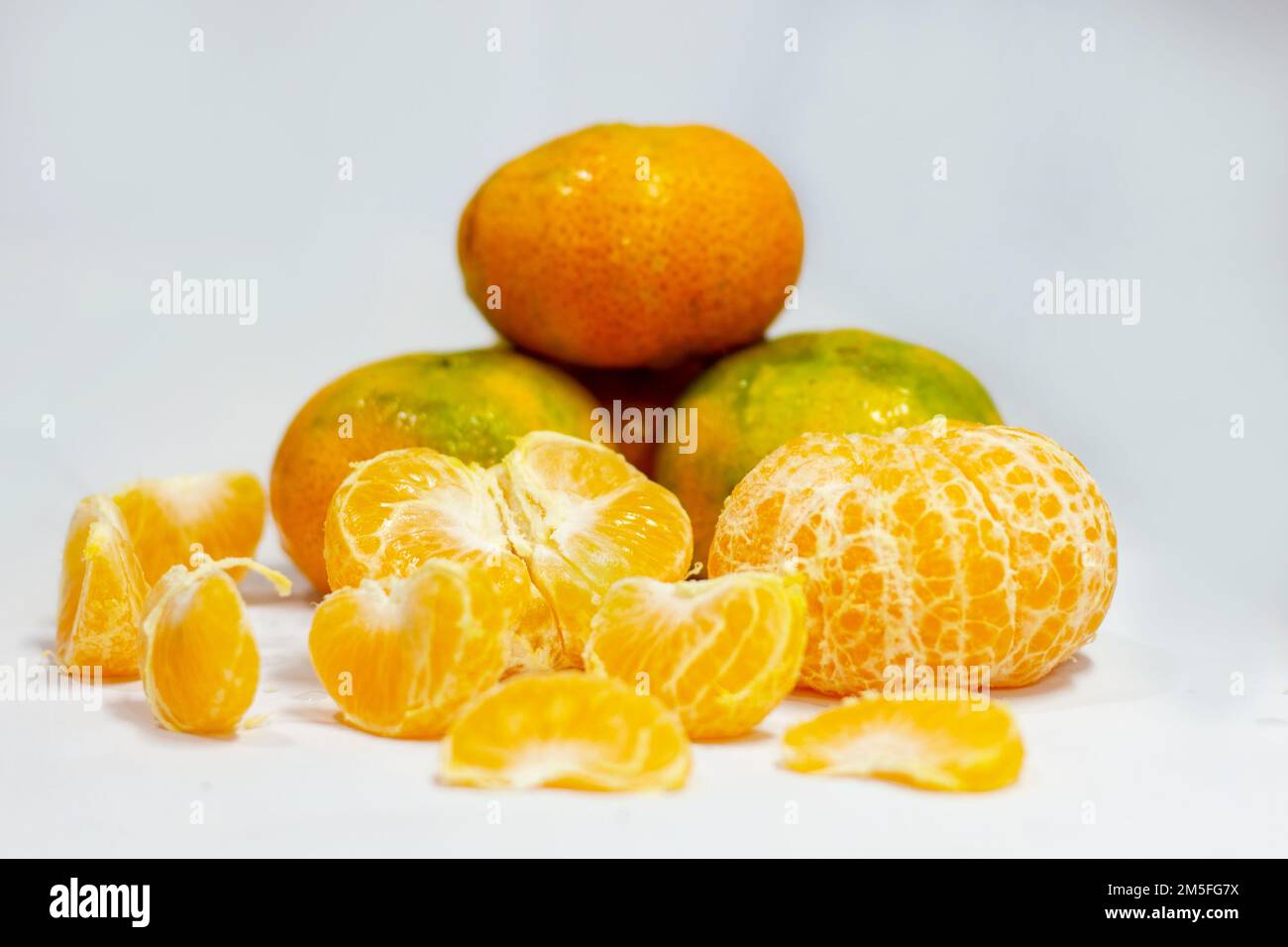 several tangerines and several pears on a white plate Stock Photo