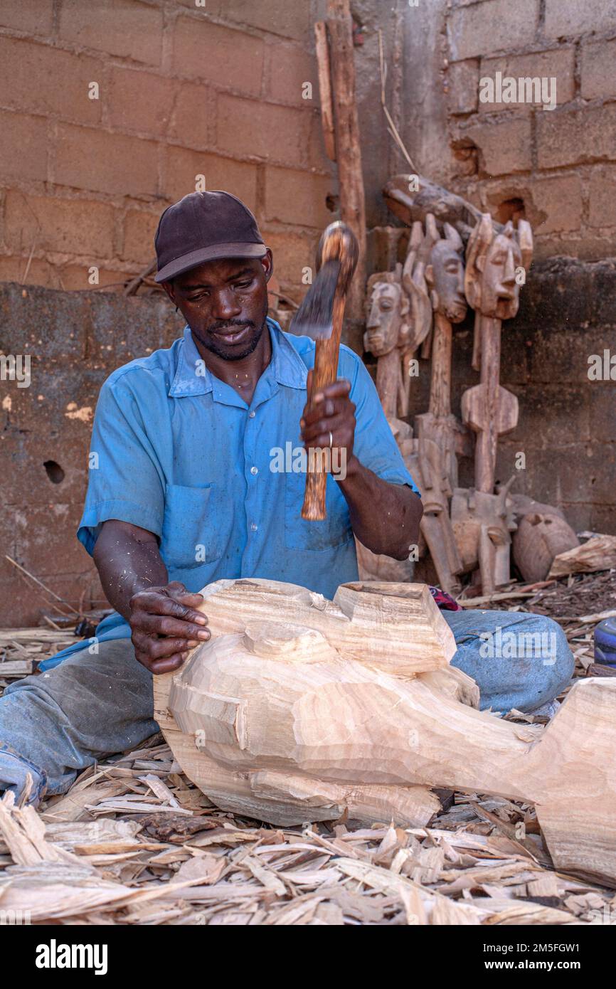 African puppet maker carving wood .Mali's tradition in
