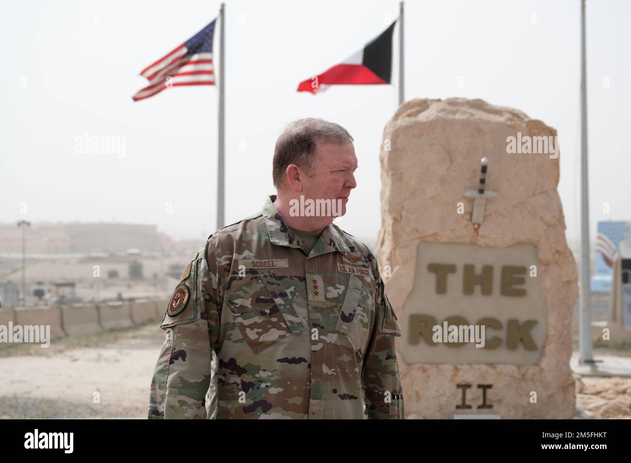 U.S. Air Force Lt. Gen. Richard W. Scobee, chief of the Air Force Reserve and commander of the Air Force Reserve Command, stands in front of The Rock at Ali Al Salem Air Base, Kuwait, March 12, 2022. The purpose of the visit to ASAB, which boasts a large Reserve presence in the CENTCOM area of responsibility, was to speak with deployed Reserve Citizen Airmen, recognize their efforts and get firsthand feedback to help the AFR train and equip combat-ready Airmen. Stock Photo