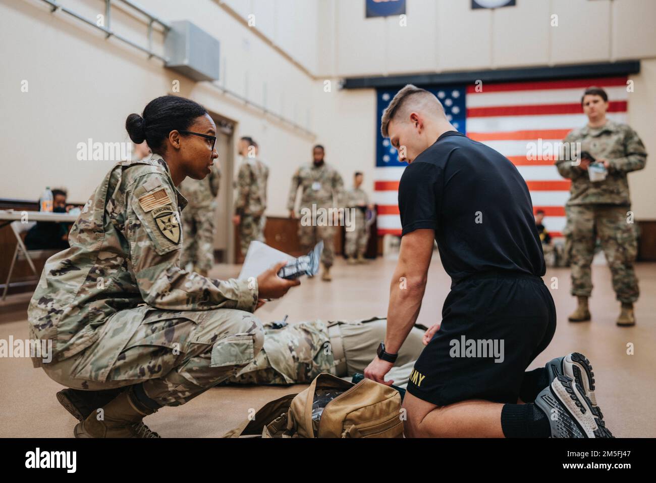 U.S. Air Force Tech. Sgt. Malissa Richardson(left), a Med Tech with the Joint Communications Support Element, instructs Spc. Micheal Crantson on different ways to treat battlefield wounds and extremities during the 335th Best Warrior Competition, at MacDill Air Force Base, Florida, March 12, 2022. Contestants from the 335th Signal Command (Theater), 200th Military Police Command, and Army Reserve Legal Command, participate in the Combined Best Warrior/Best Squad competition in Tampa, Florida, March 11-19, 2022. The two finalists from each command will then compete at the United States Army Res Stock Photo