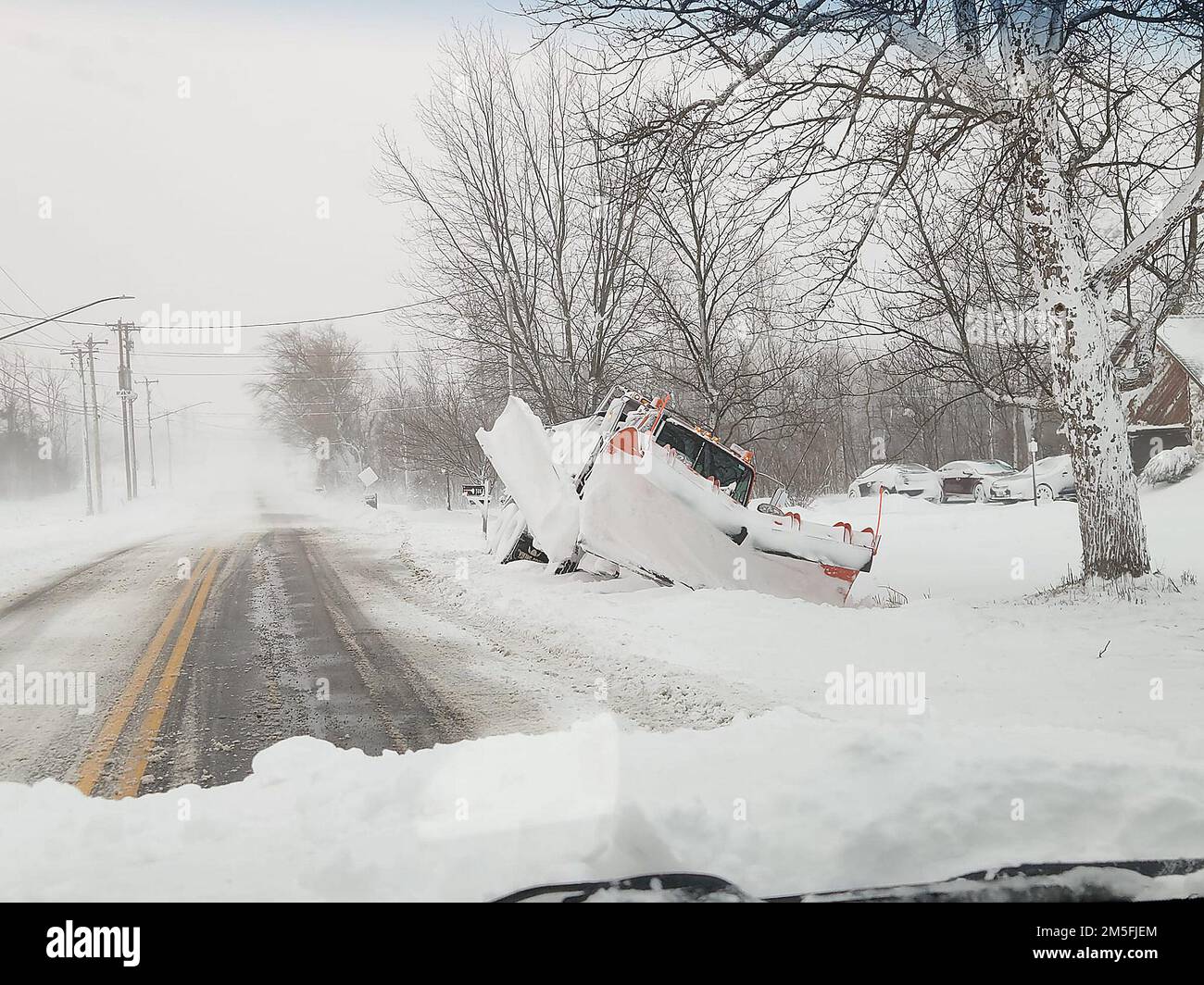 Lancaster, New York, USA. 24th Dec, 2022. A snow plow is stuck in the